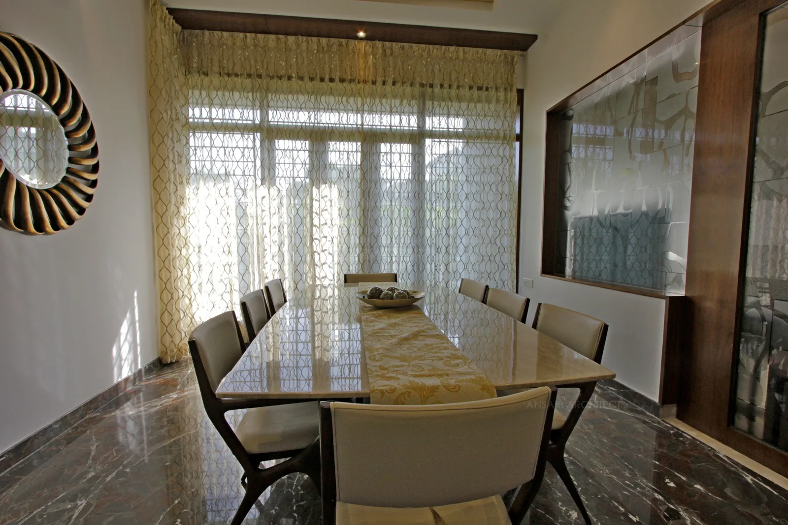 White walls and marble floor hit the contemporary style, recessed lights providing soft glow, large amount of natural light filtering through drapes of the curtain clearly seeks attraction.