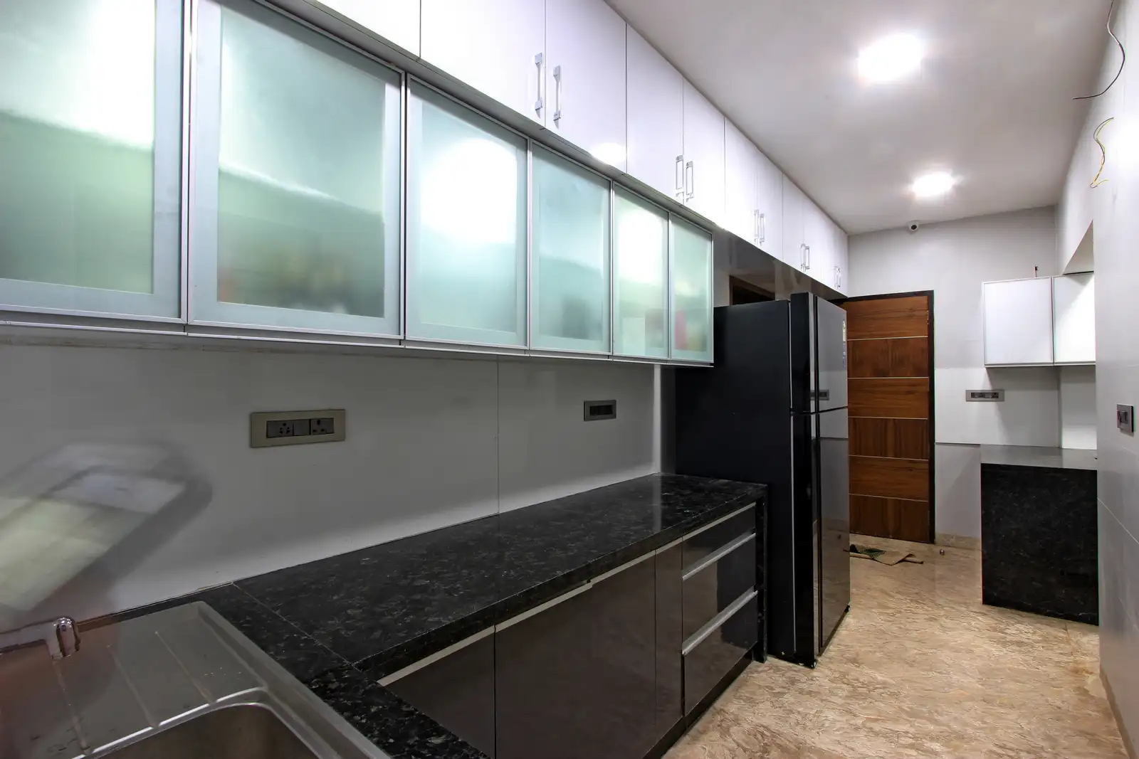 Hidden lights in overhead cabinets and platform drawers add to vivacity. The floating shelves allows minimal storage above.