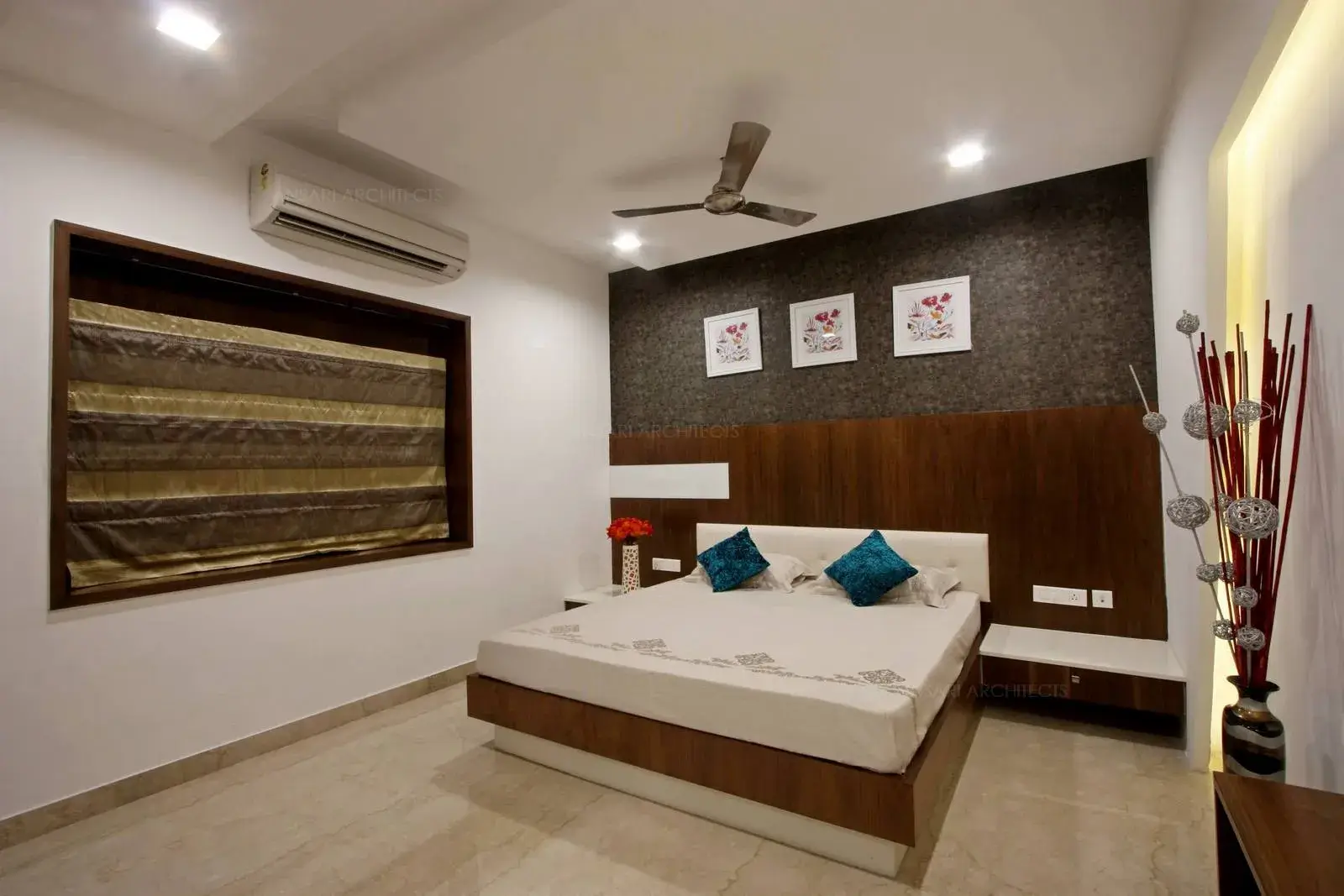 False ceiling and flooring tiles highlights the space along with artifacts used for ornamentation and the choice of colours complement the bedroom area.