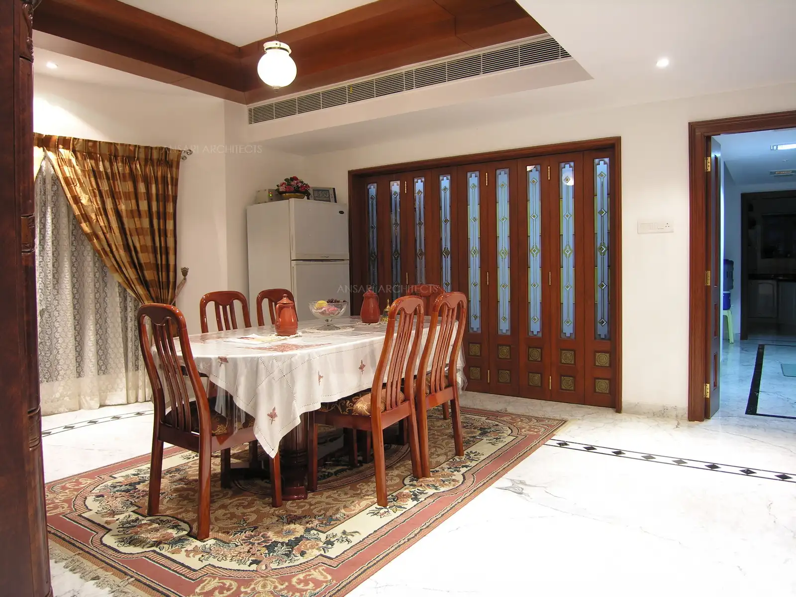 The dining room with the wooden furniture.
