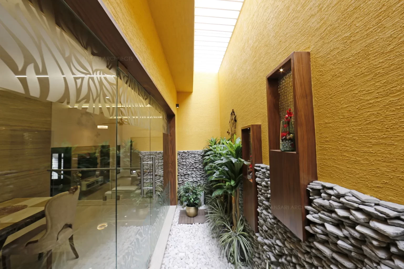 The courtyard is a play of different textures the walls, veneer finishes and the landscapes, the material palette is raw and natural .Simple niches are created.Thereby the space opens to welcome natural light creating an interplay of light and shadow elevates the overall spirit.