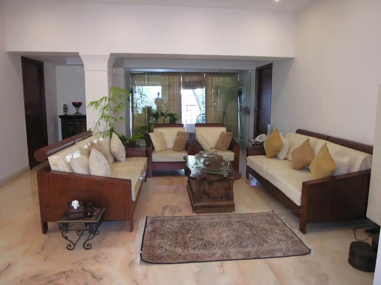Customized wooden sofas designed in the living room to match the simple and contemporary interiors.
