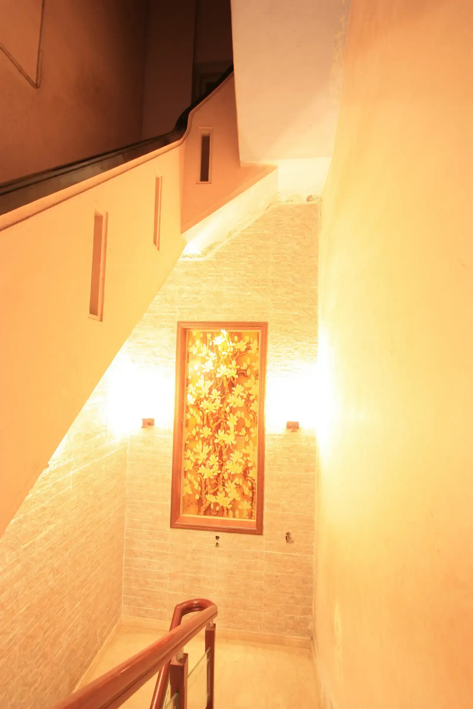 The staircase walls have been clad with stone looking tiles to provide easy maintenance of this high traffic staircase area