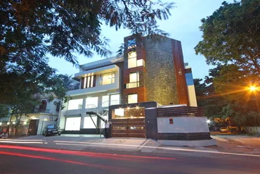 a building with a fence and trees