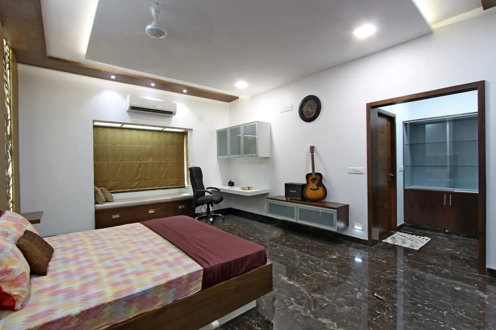 The ceiling creates layers of lighting which exaggerates the sense of a space. The light emanating from cove lights add more depth. Flooring is chosen to be luxurious and offers high lustre creating a visual impact and the sitting window looks elegant with the storage and seating, study table and floating cupboard looks interesting.