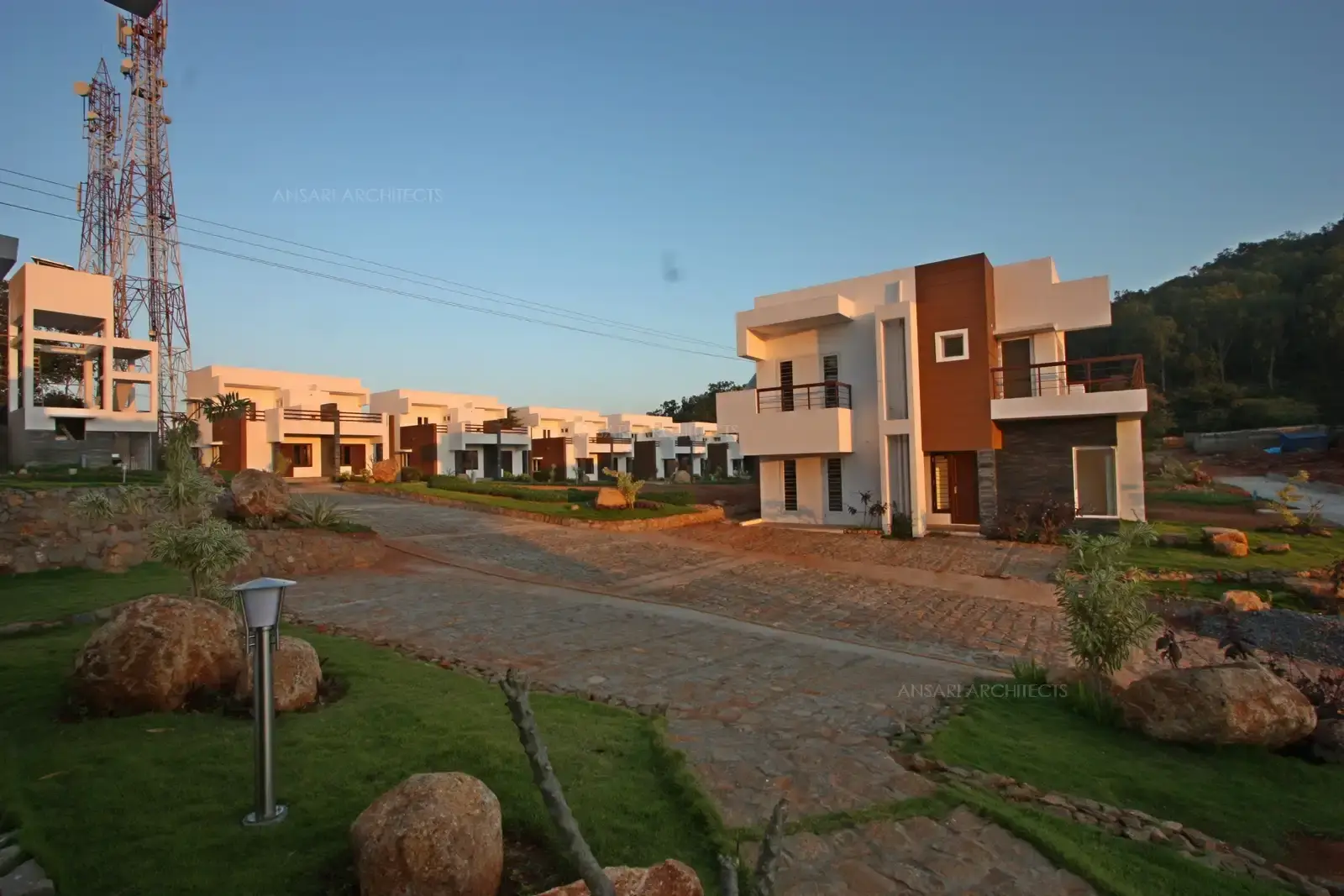 The use of boulders and the preservation of the natural slope of the land help the development blend seamlessly with the surrounding landscape.