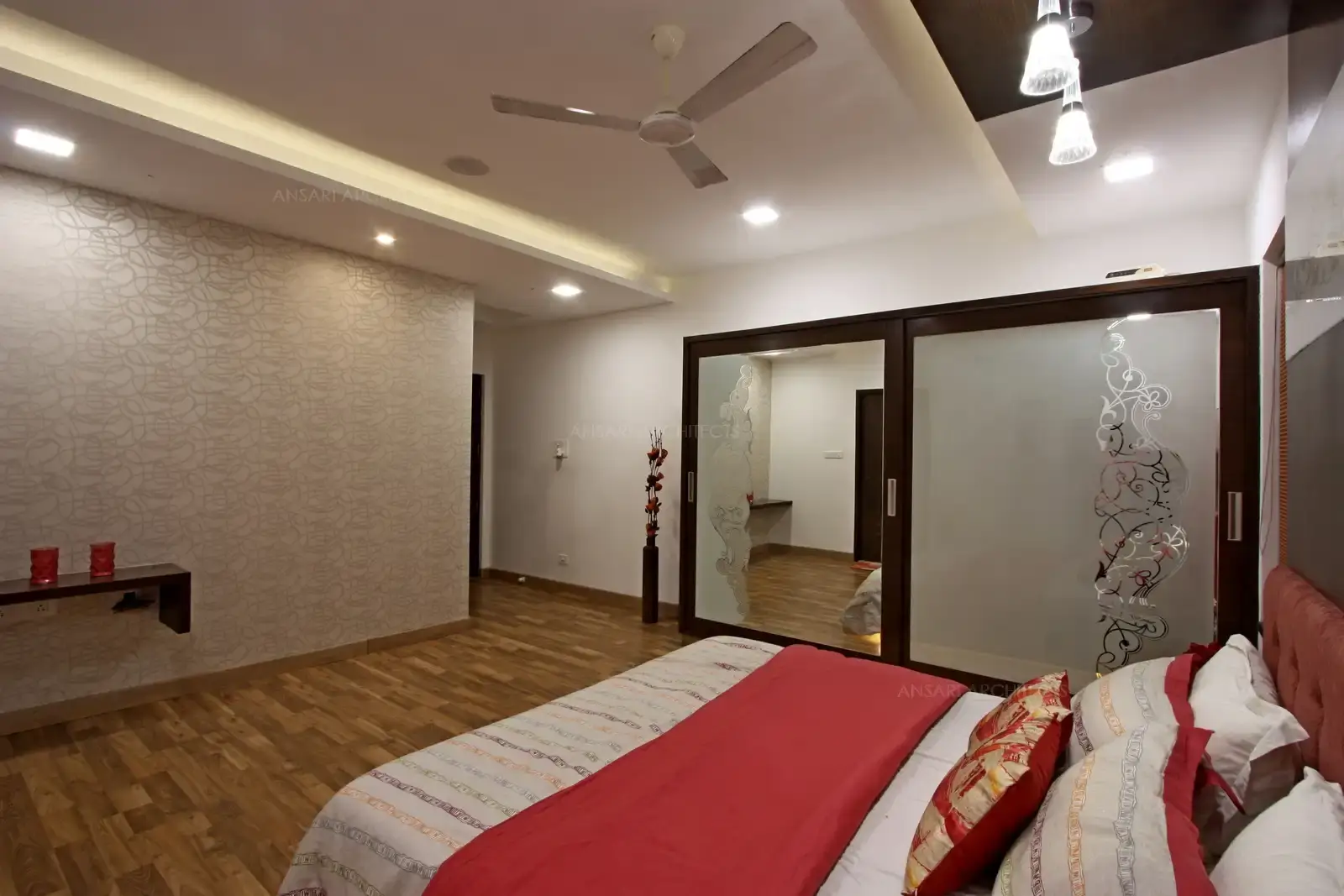 The bedroom is spaced out very well by using the window side table and with large mirrors adding more depth to the room.