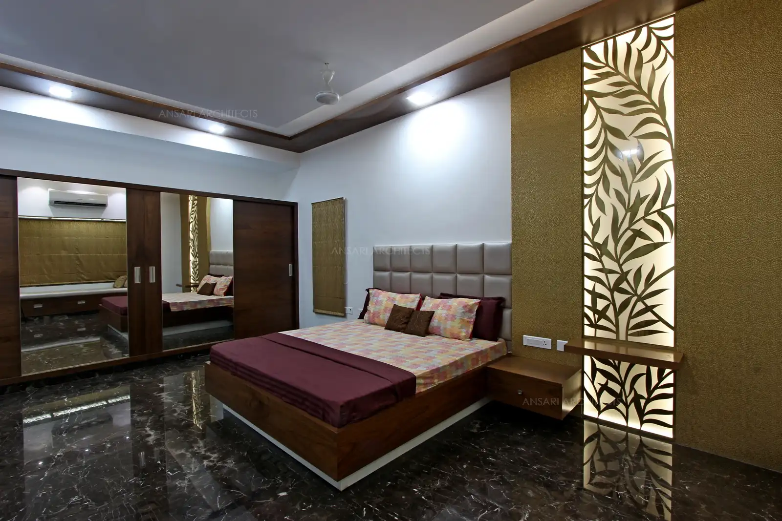 The bedroom exudes a sense of luxury, both in visual and spatial terms. Completely neutral colour palette ehances the walls, the gold creates a sese of coherence, making the space feel more open. The dark neutrals of veneer look rich and give depth. Luxurious headboard creates a focal point in small space,a fabulous fabric cushion headboard adds personality. Wardrobe with an antique finish of mirrors.