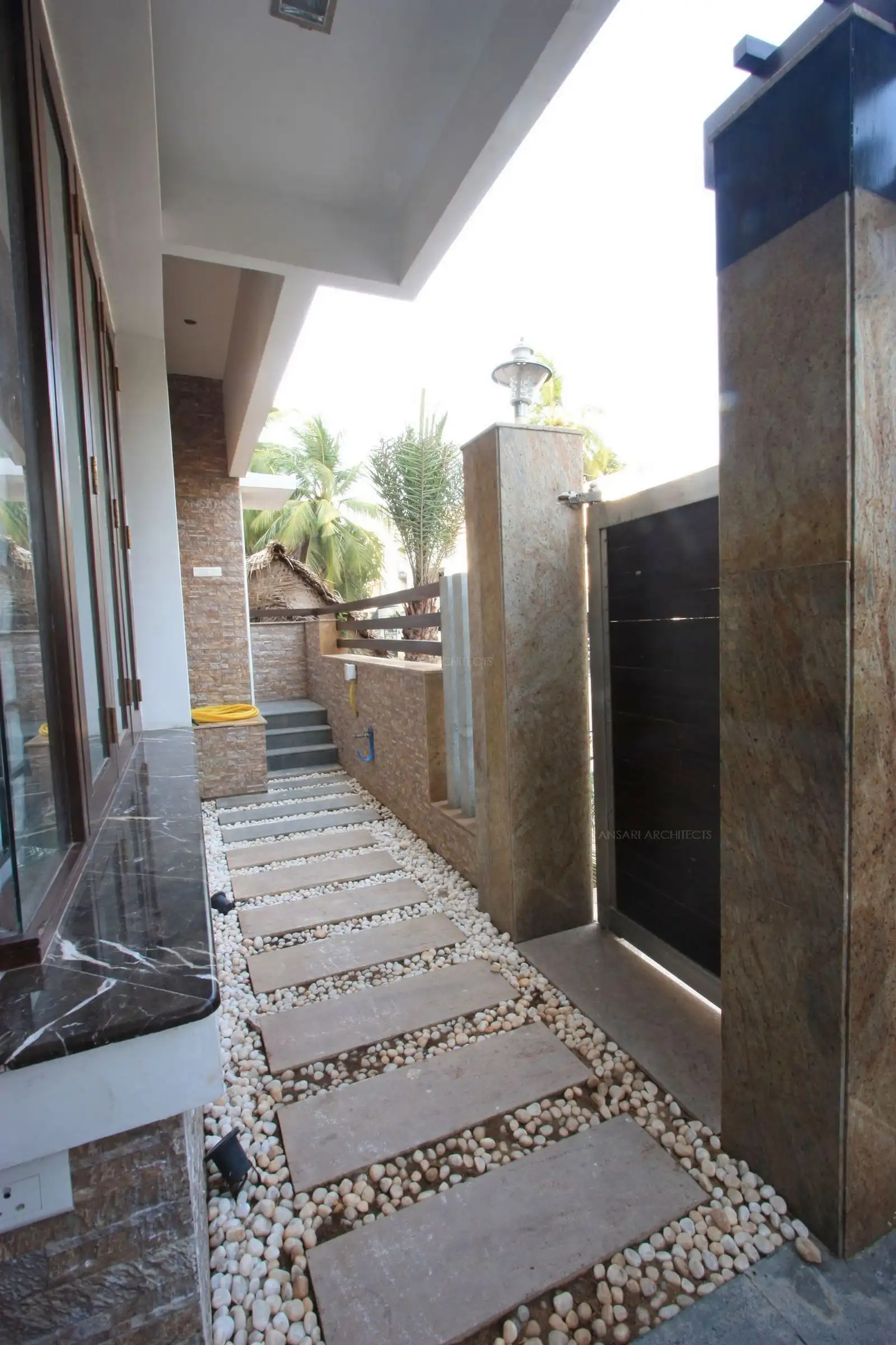 The passage around the compound wall has been turned into a stone and pebble pathway