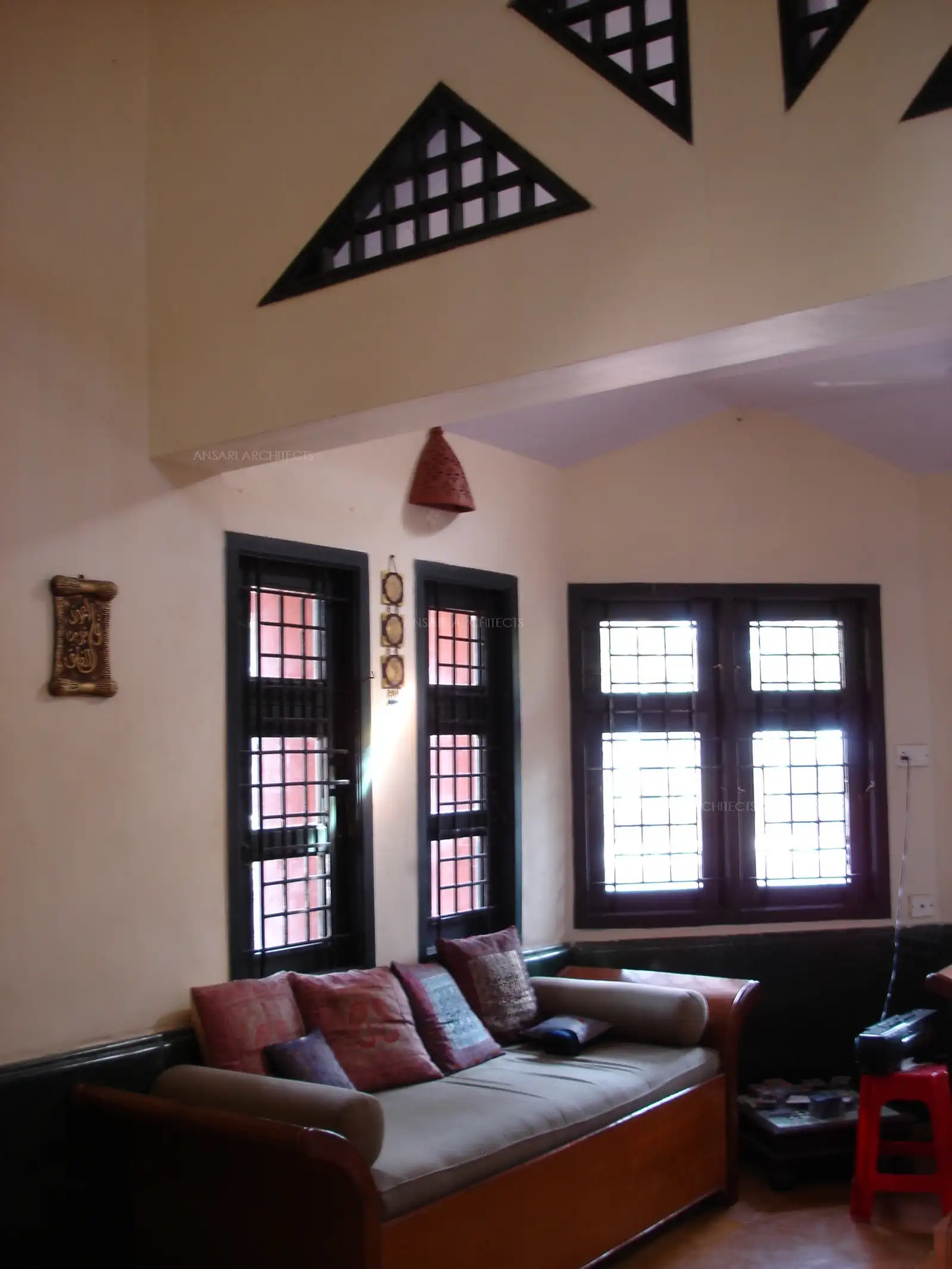 High ceiling with wooden truss impression.