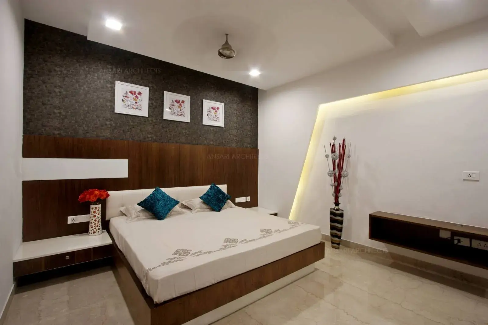 The grooves have been provided for lighting to highlight the wall with functional table for television and study.