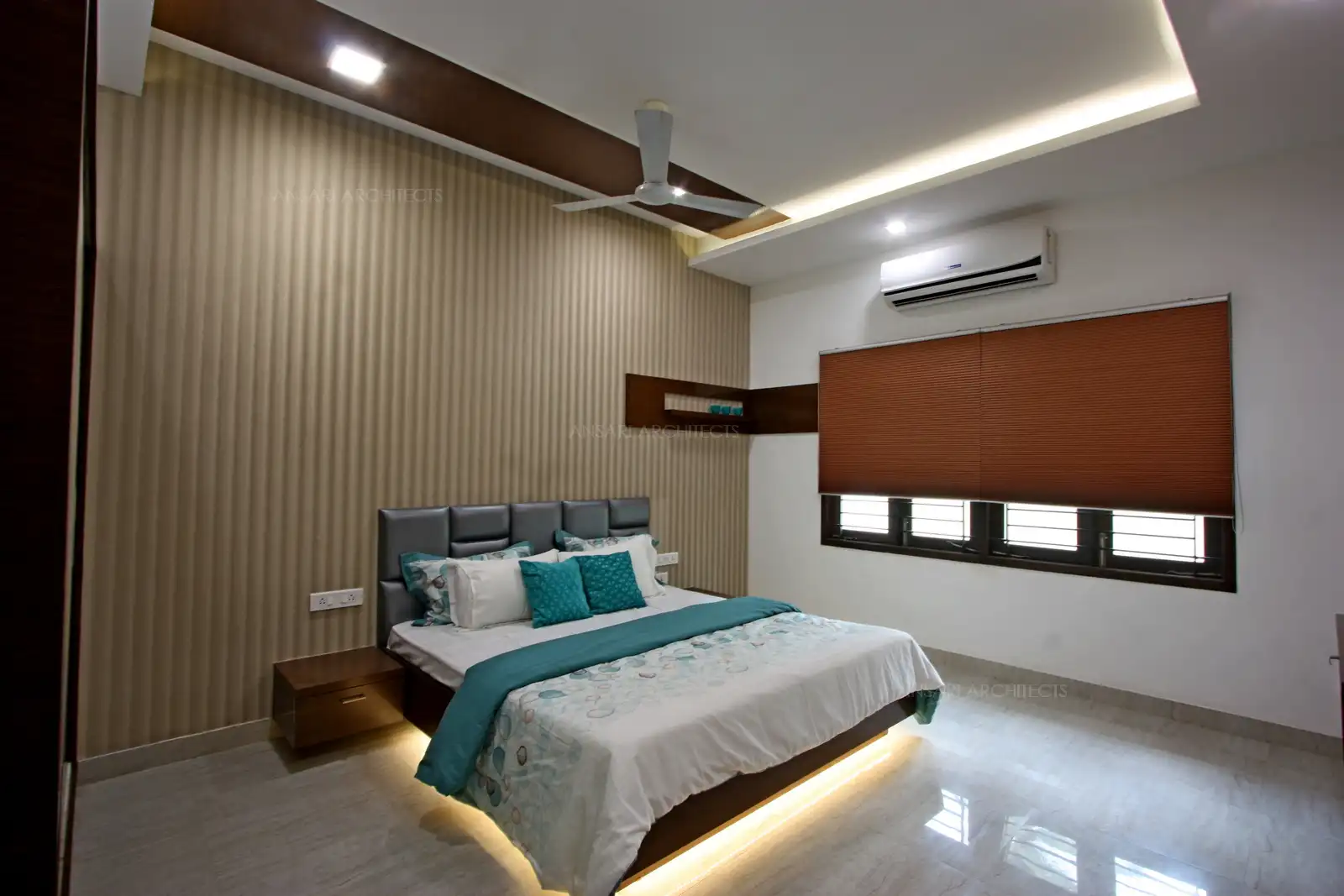 Marble flooring and the selected wallpaper finish enhance the royalty of the bedroom.