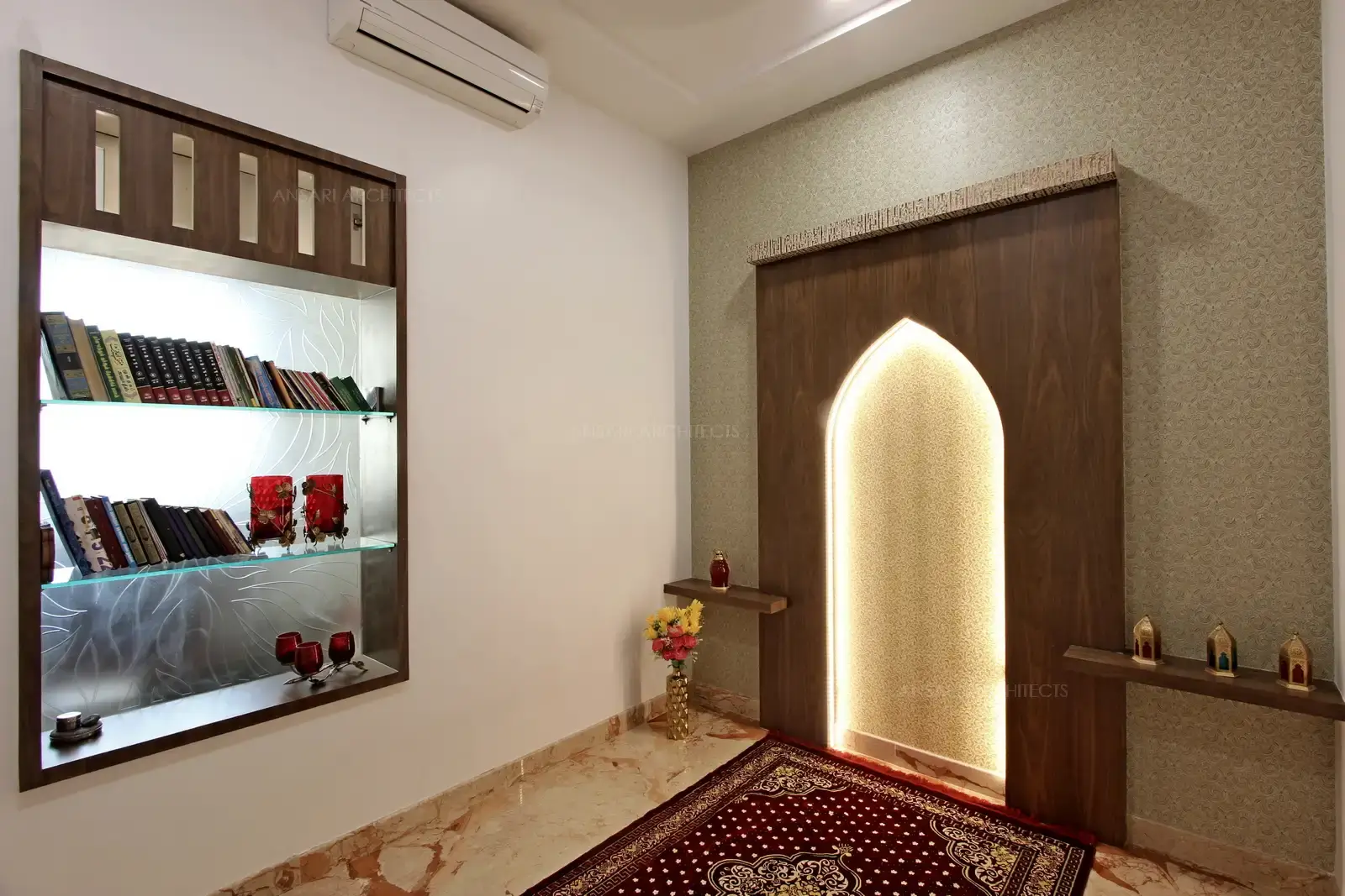 The prayer room gives a heavenly feel with wooden panelling and lighting fora spiritual effect. Glass alcove storage is provided at the adjacent wall.