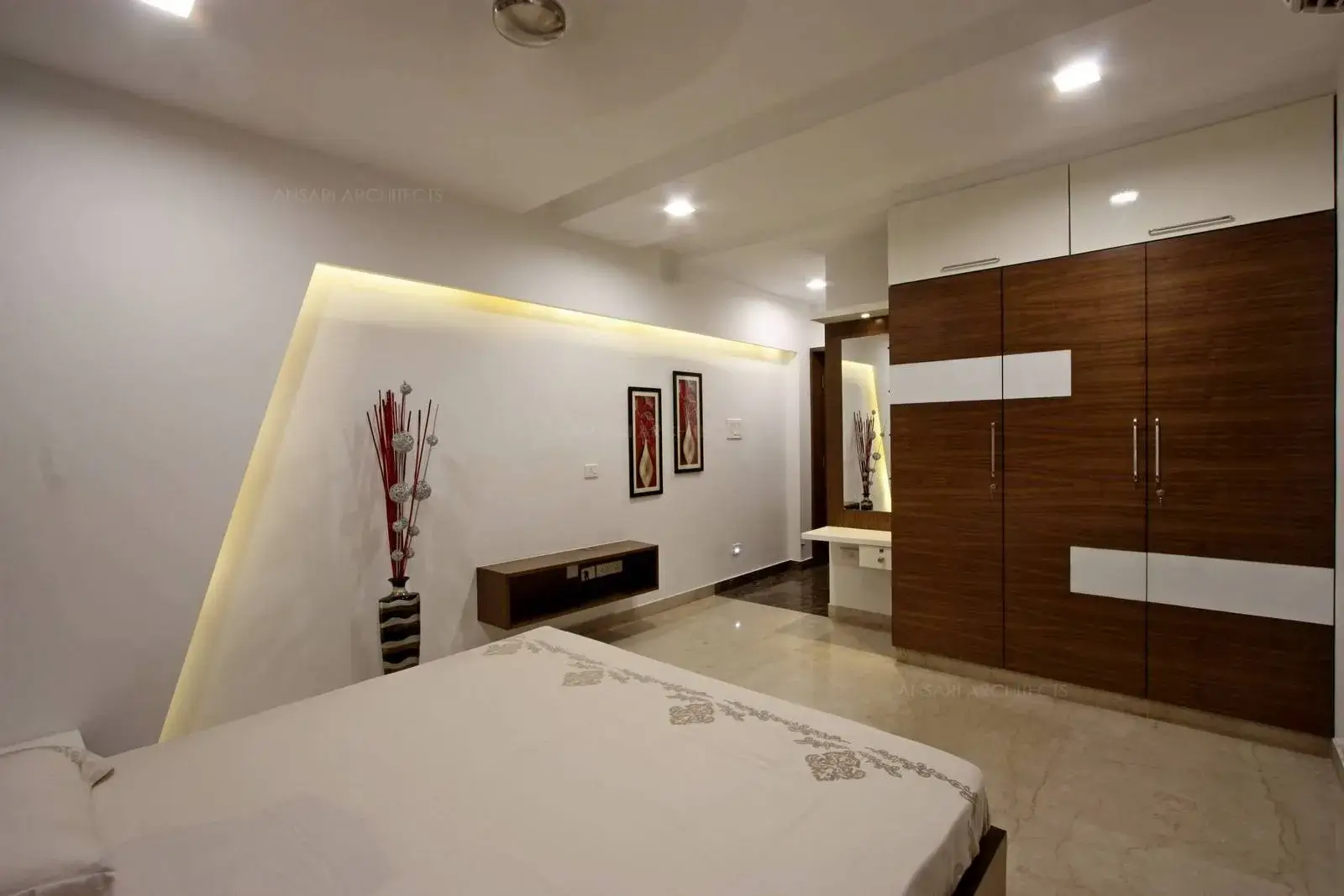 The television unit with veneer finishes and wardrobes create a dramatic look for the bedroom.