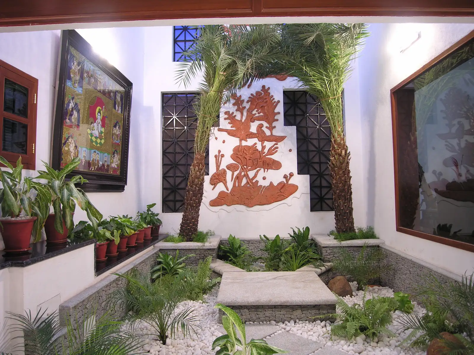 The courtyard is landscaped with Multilevel stone platforms and natural plants purifying the air inside with possibility of outside ventilation through the grills protected with mosquito mesh and real tall palm trees.