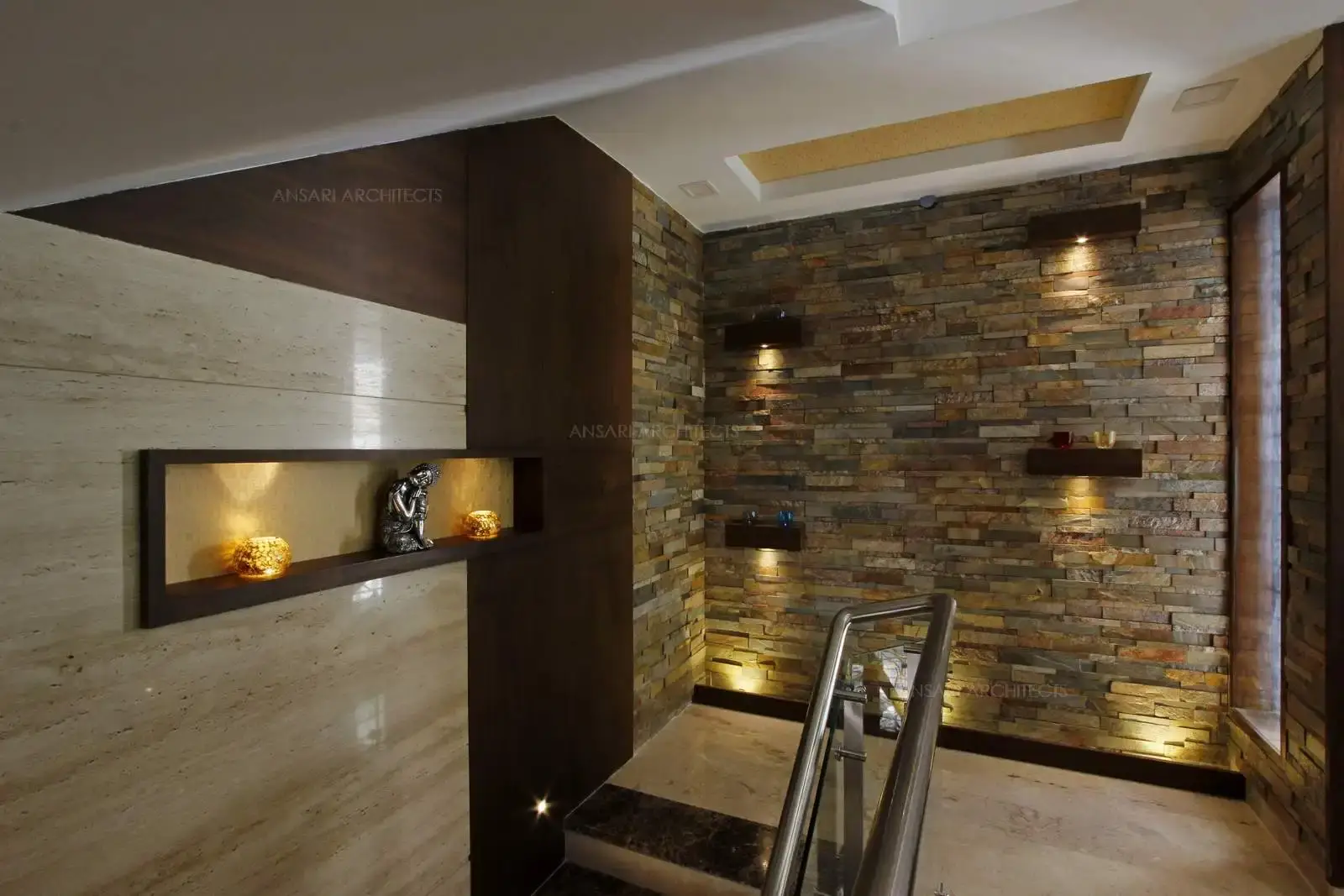 The stone texture is the visual component that satisfies the sensory experience. Here, the indent wood on the wall is accentuated by light and bright spotlight create a textural harmony between various elements on the walls. Recessed ceiling with light provides a subtle effect and the window creates an inviting spot.