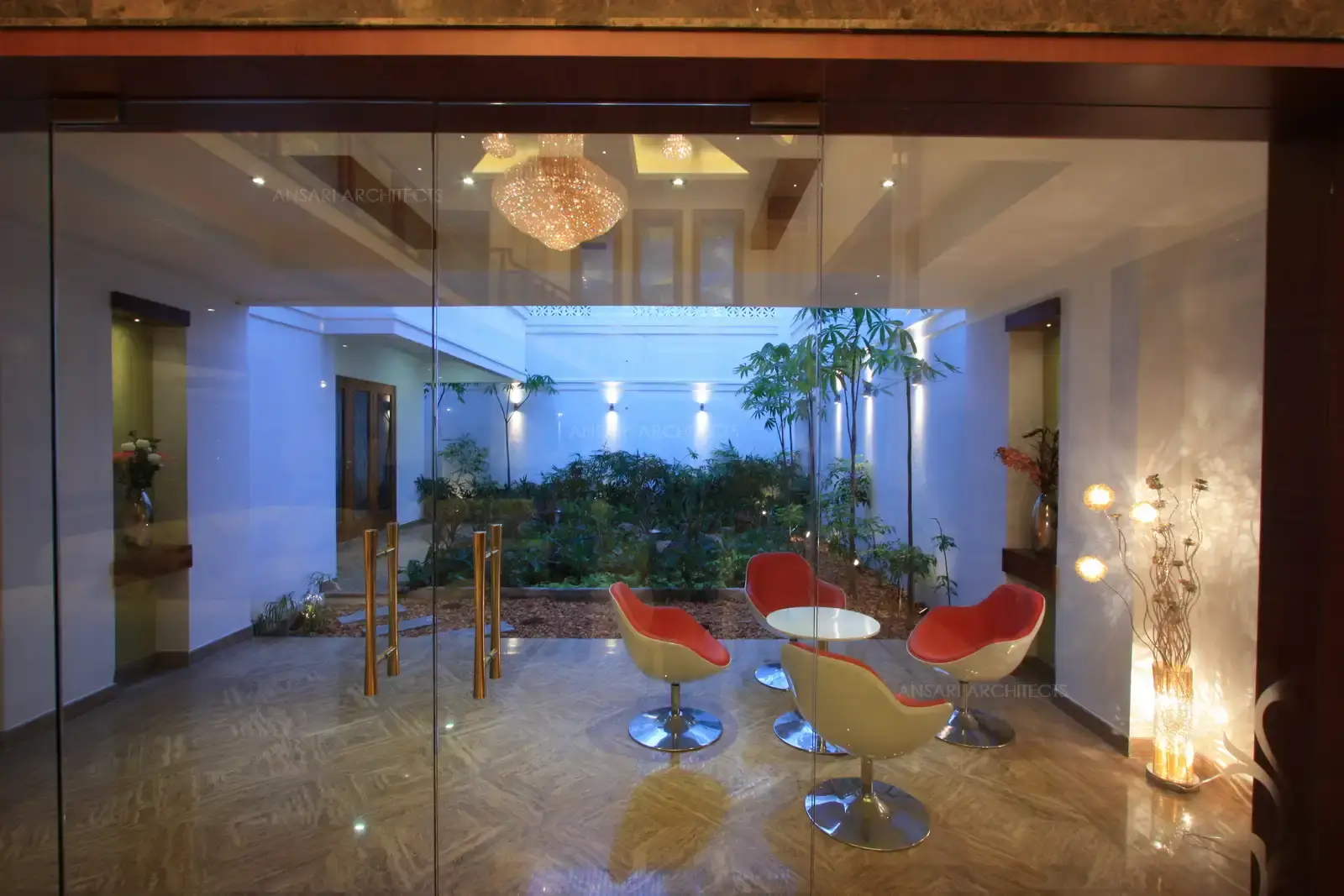 Courtyrad in the living room is provided with relaxed and contemporary seating along the landscape area.