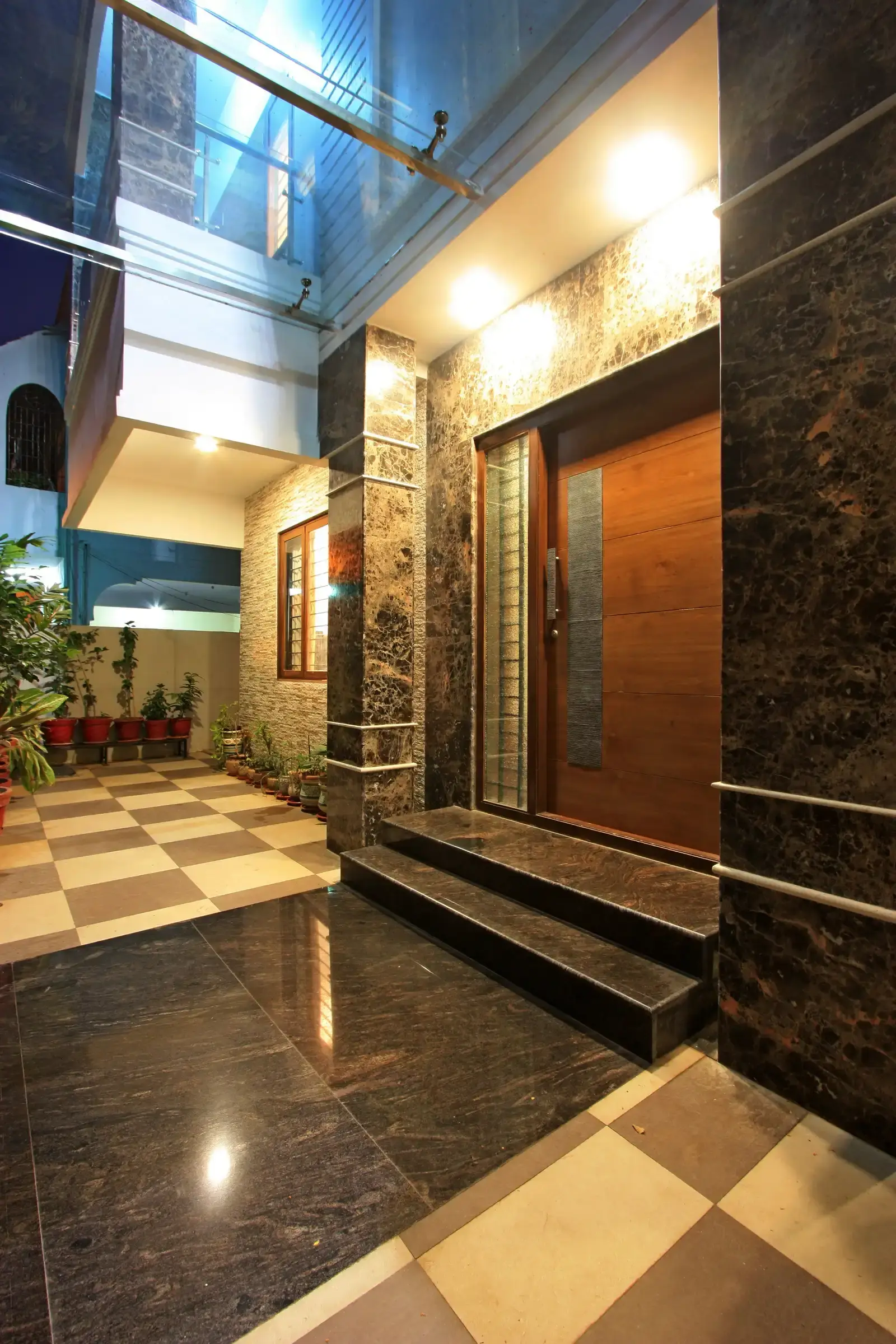 Glass canopy at the entrance door gives shade with an open feel as well as adds to the aesthetic view in the exterior.