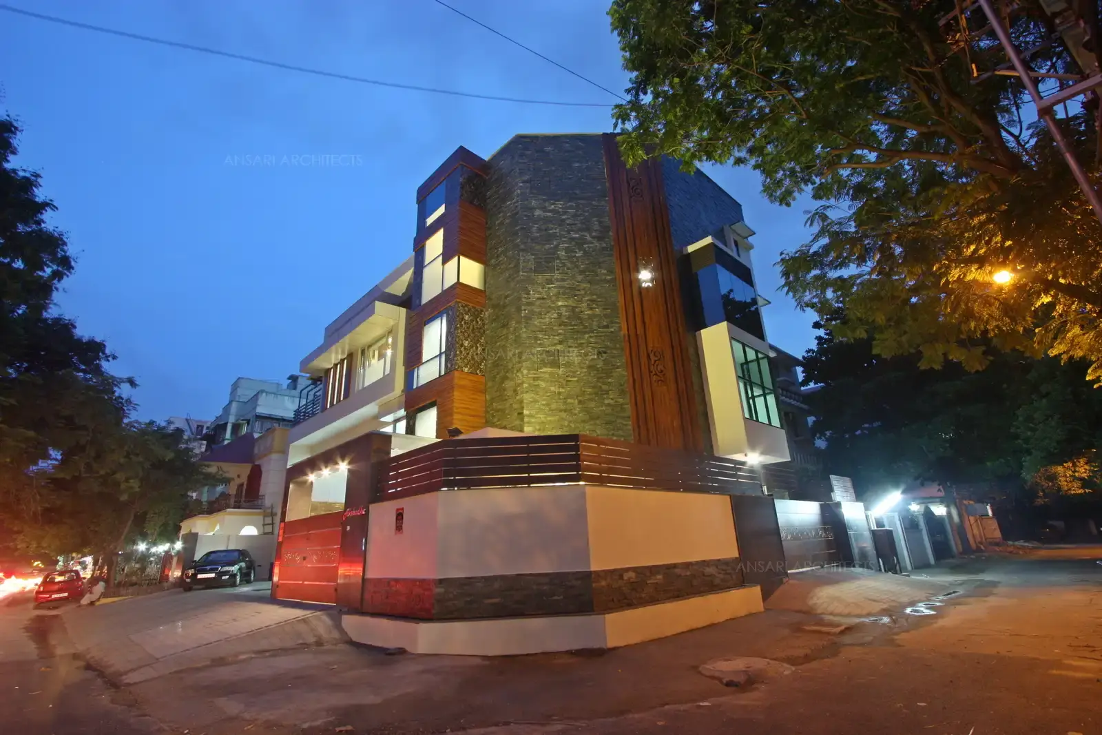 The stone textures create an individualism, all the materials fused to address local contexts. Light and shadow play an imporatant role in the facade, Wooden sun breakers in the contemporary home with combination of sturdy materials. Angular facade here creates an extraordinary form and the materials render a rustic finish.