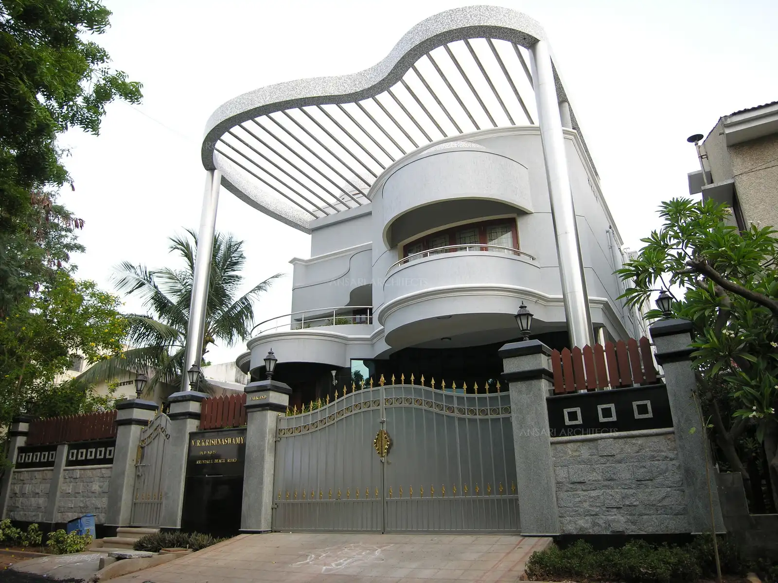 The curved balconies are balanced by a tall pergola on top.
