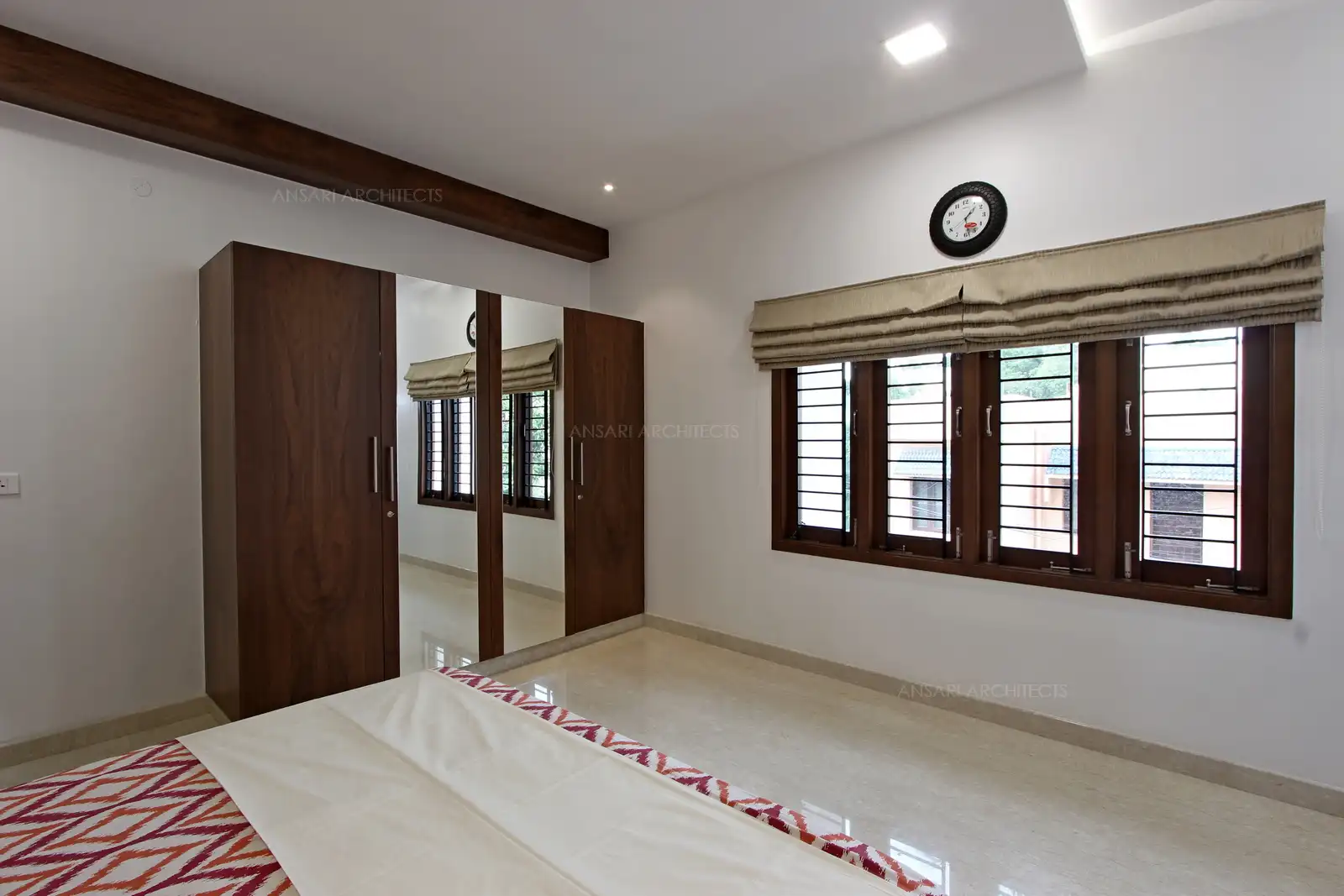 The openings bring in subtle natural light that warms up the space and the marble flooring perfectly blends with the space and decor elements.