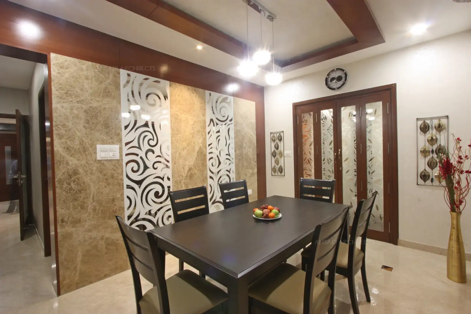 The accent wall with abstract stencil features and marble cladding livens the space with the wooden texture framed around with pristine marble flooring.