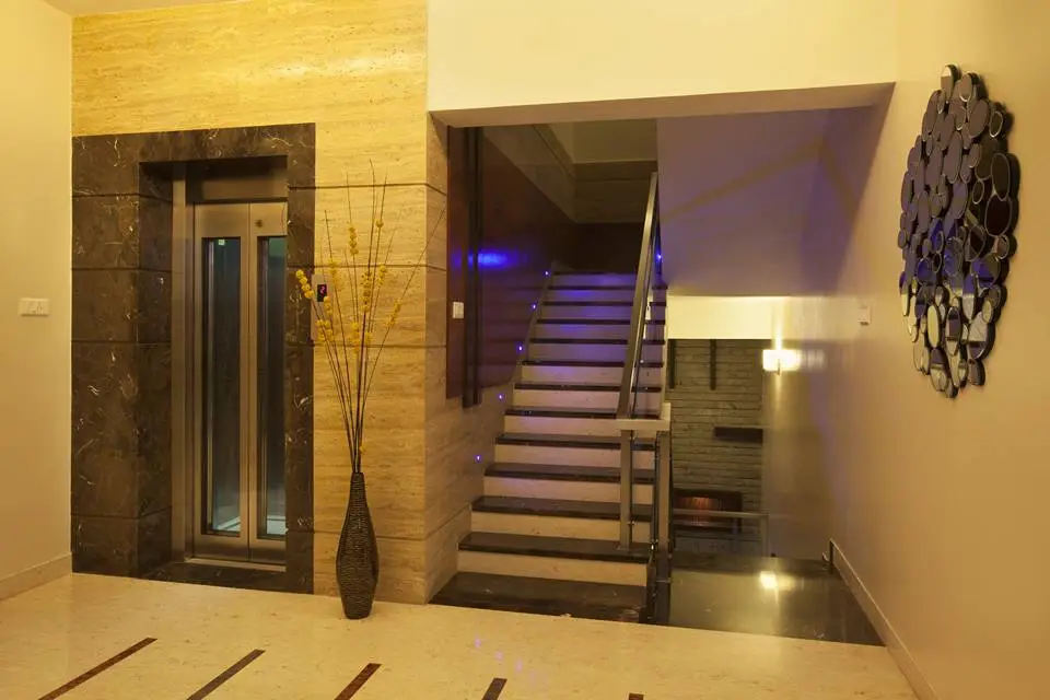 Marble and wooden cladding on lift and staircase wall on the second floor.