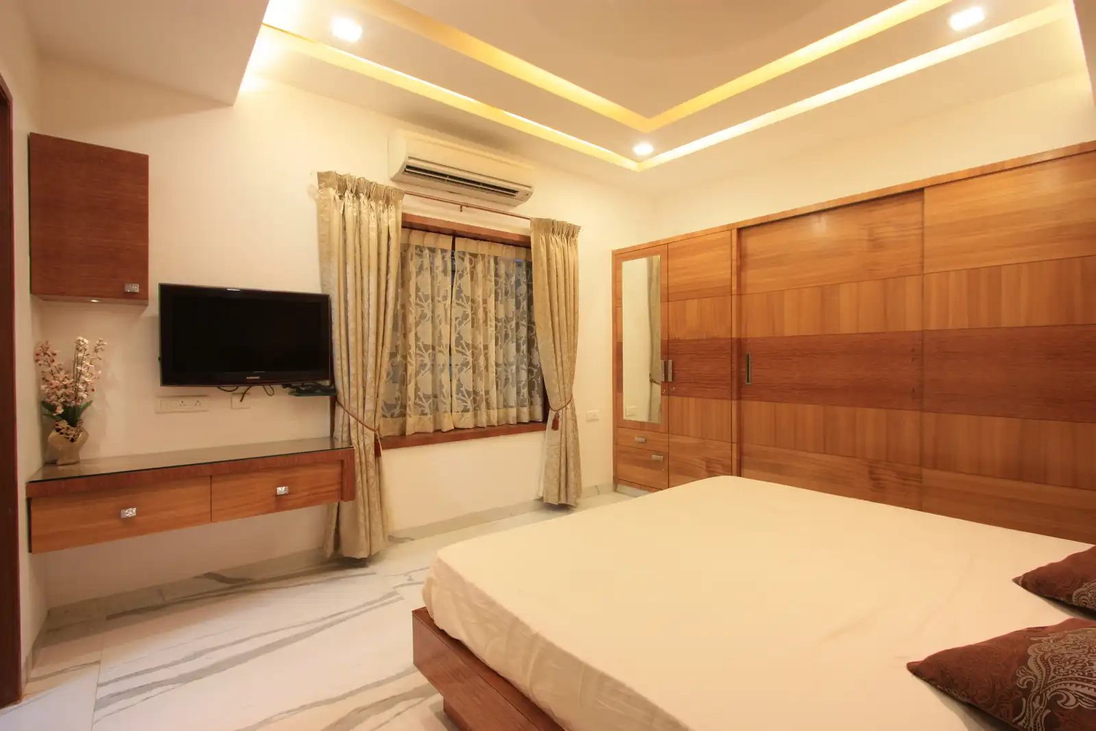 Contemporary style is reflected in the TV unit false ceiling of this bedroom-2.