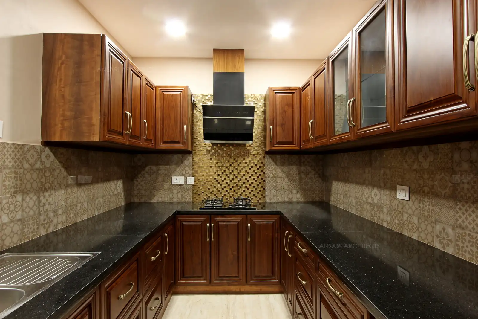 The space looks modish and warm. Plenty of storage, the wood textures create chic decor uplifted with warm panel lights and backdrop tiles with abstract patterns give comprehensive kitchen decor.