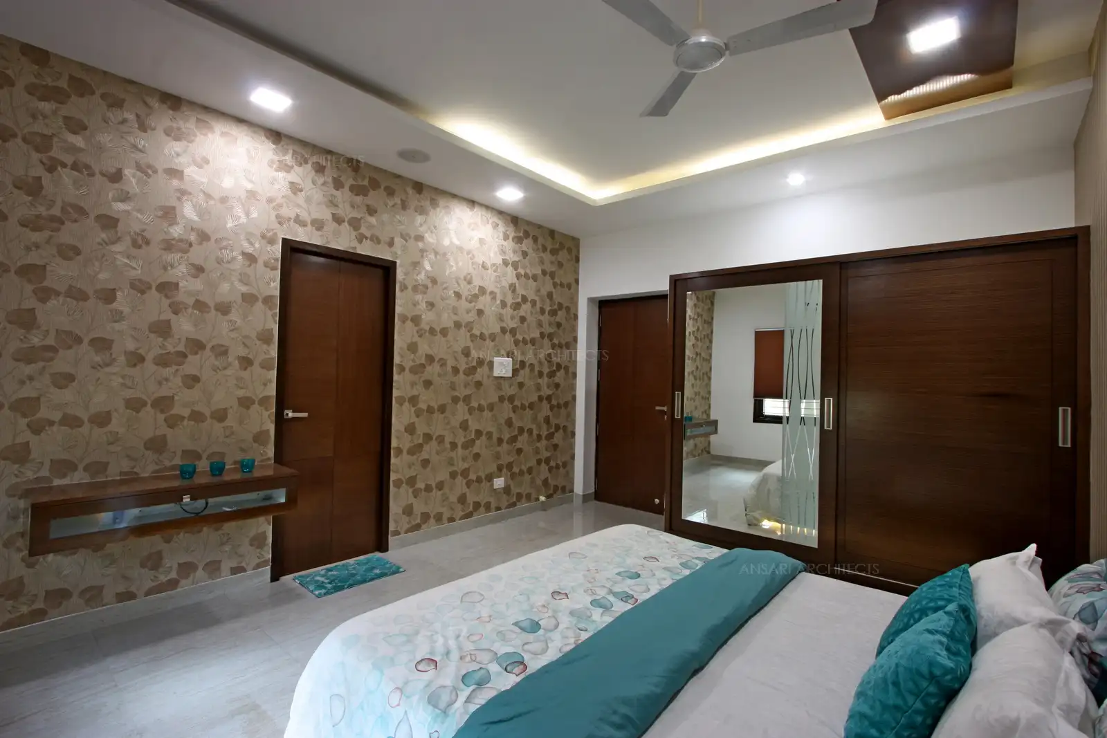 Camouflaging doors with paneling and finer details of handles and lights render very contemporary style to the bedroom.
