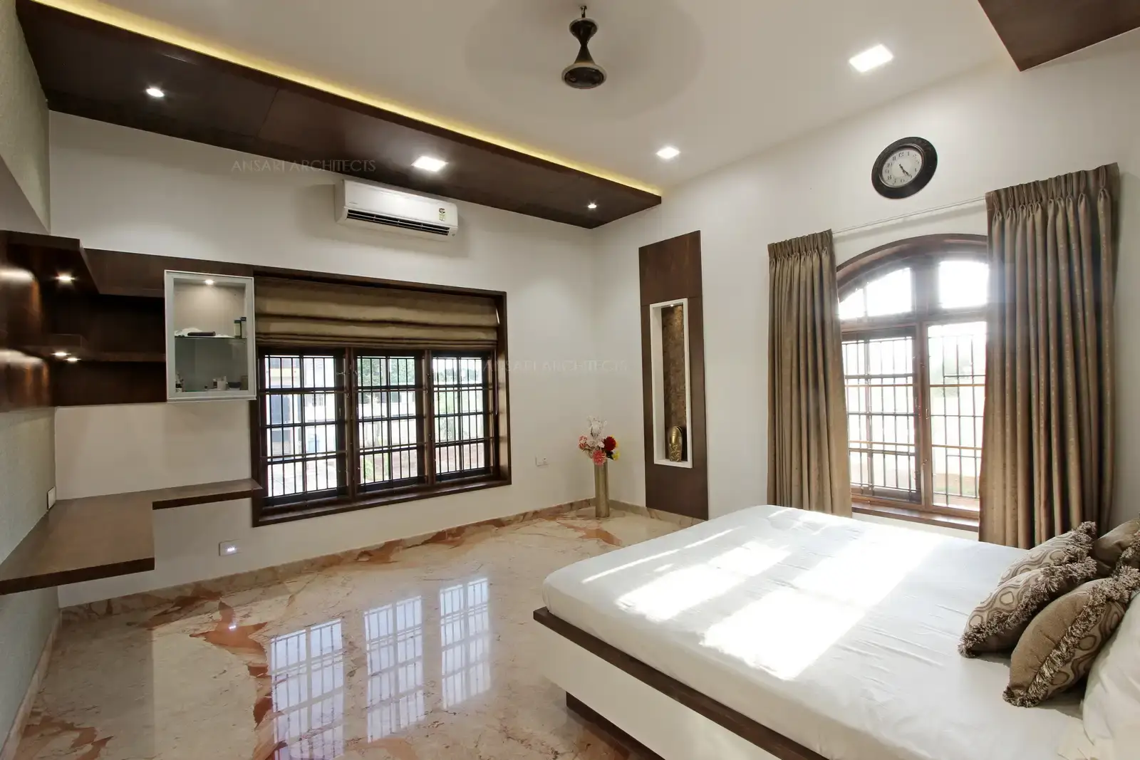 The spot ceiling with concealed wall lights in a soft glow gives a dreamy effect. Veneer paneling with recessed niches, usage of corner spaces create a vogue with functional elements.
