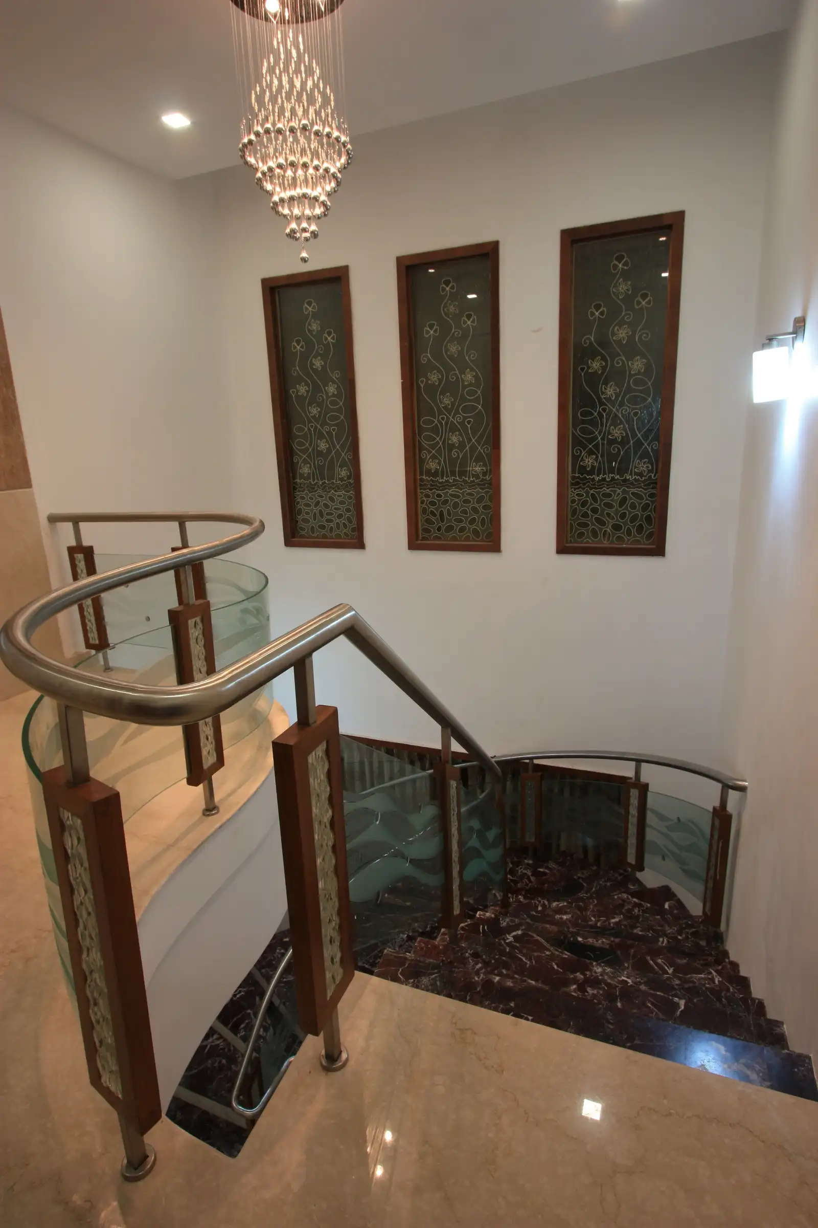 View of staircase area designed with customized handrail and fixed wall on the wall.
