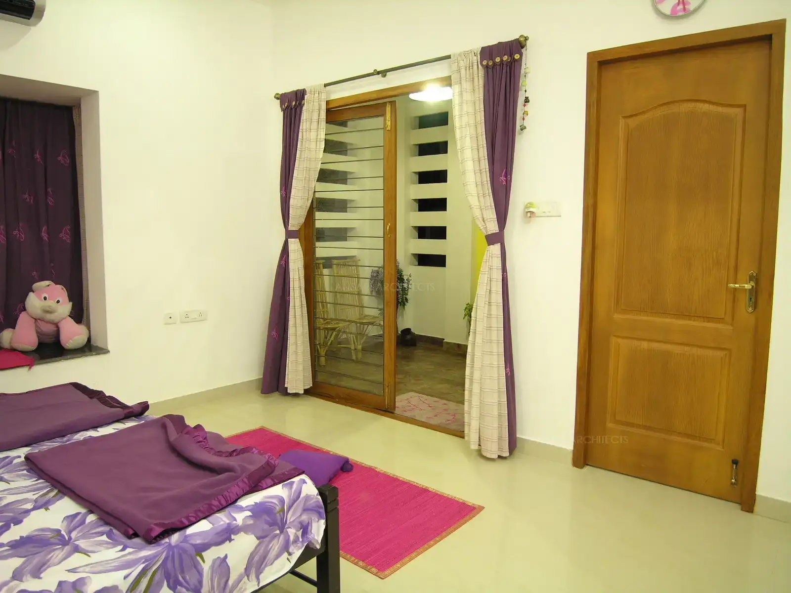 Daughter-2's bedroom has a touch of pink and purple shade in the furnishing to give a feminine look.