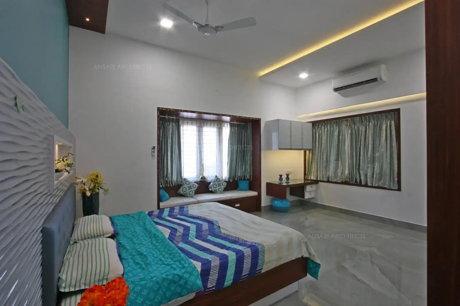The study area looks compact cabinets above the table with under lights. It's convenient and easy to incorporate. False ceiling with strip lights enhance the space.