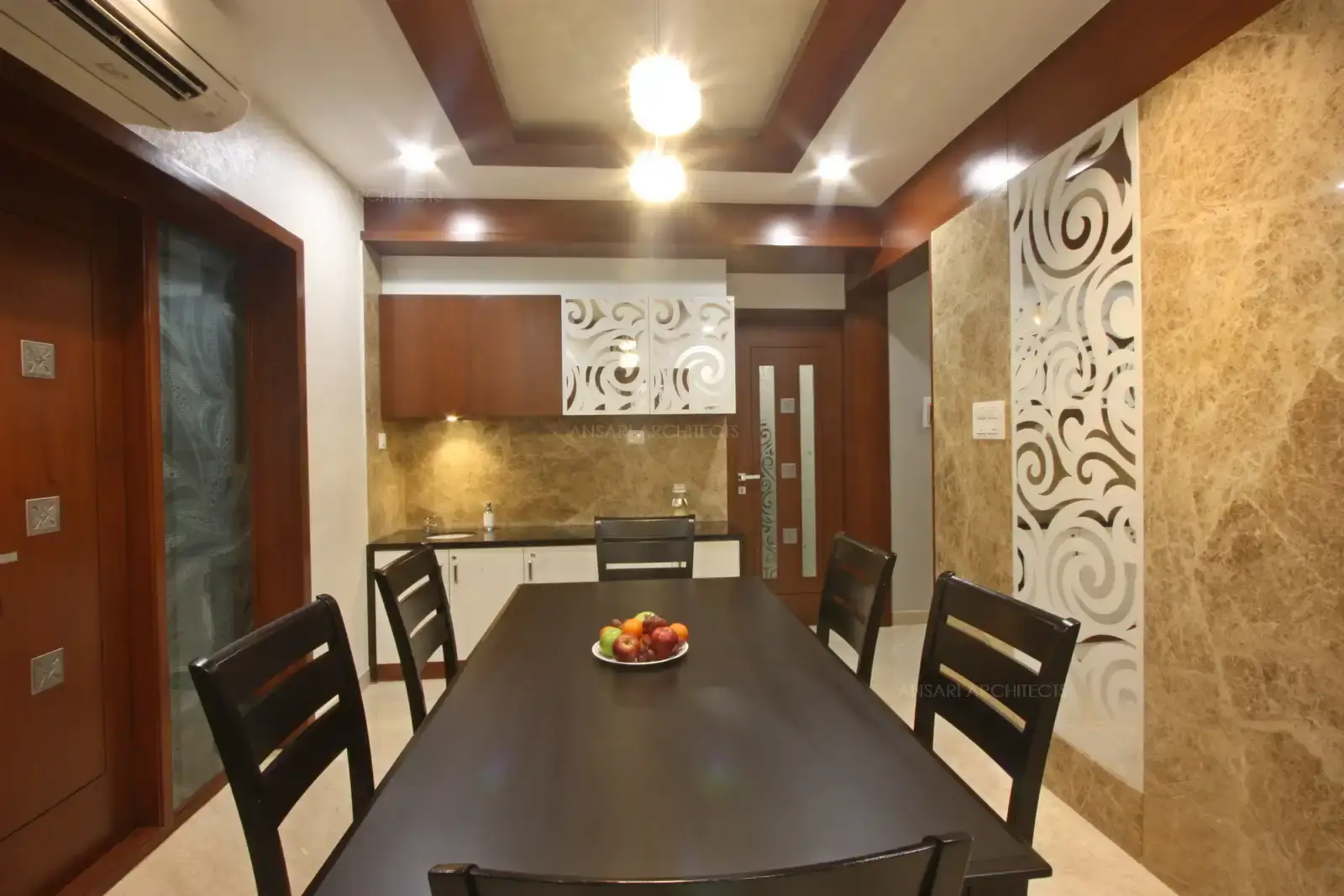 A vintage cabinet addition to the dining room, interesting patterns and wood textures, entirely glazed unit adds a sense to the storage which is compact and stramlined. False ceiling makes a mark with wooden cladding.