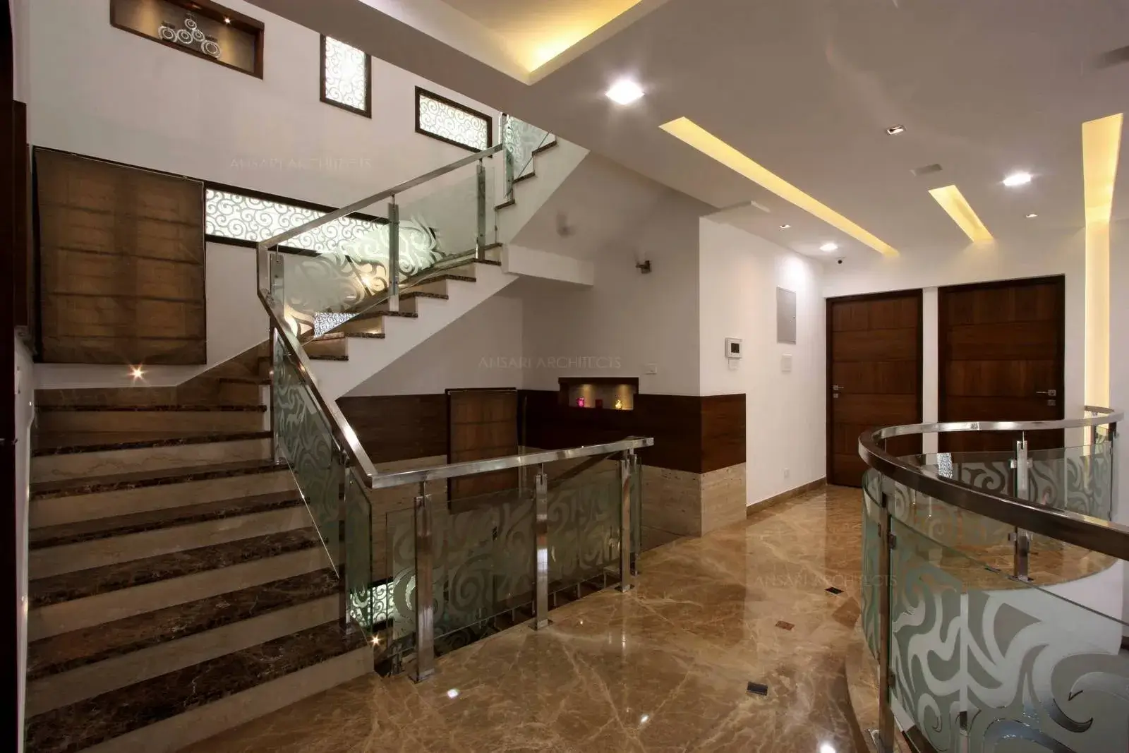 View of the staircase area with striking light entering the space through fixed glasses creating a blissful scenario.