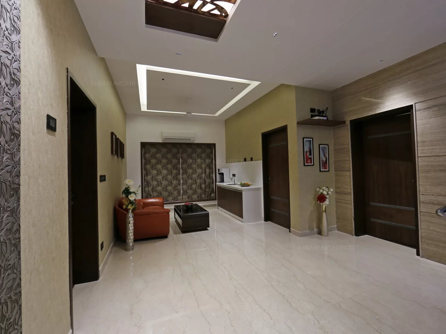 The ceiling is highlighted with decorative panels which effortlessly mixes with the design and light adds more depth. It’s a formal relaxing area with interplay of materials.
