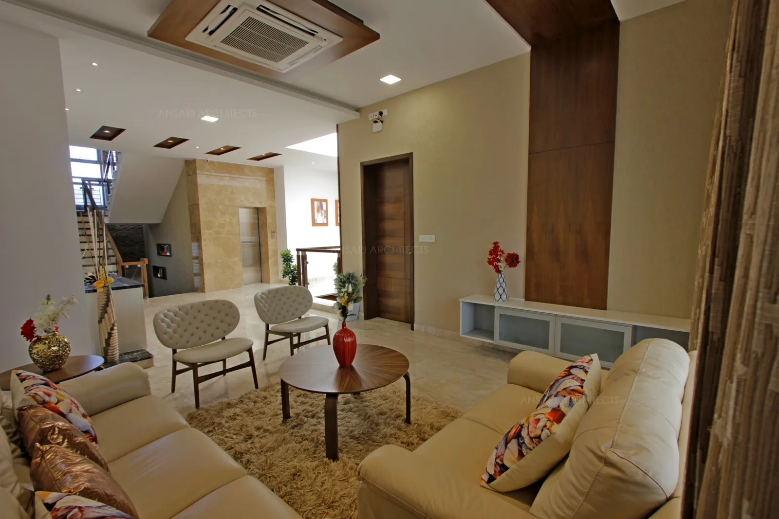 The colour scheme blends with room visually enlarges the space, more continuity delicate cushions with two chair cushions bringing balance to the space. Circular console table, the wall to ceiling panelling for the TV unit, floor rug everything lines up for a perfect family space.