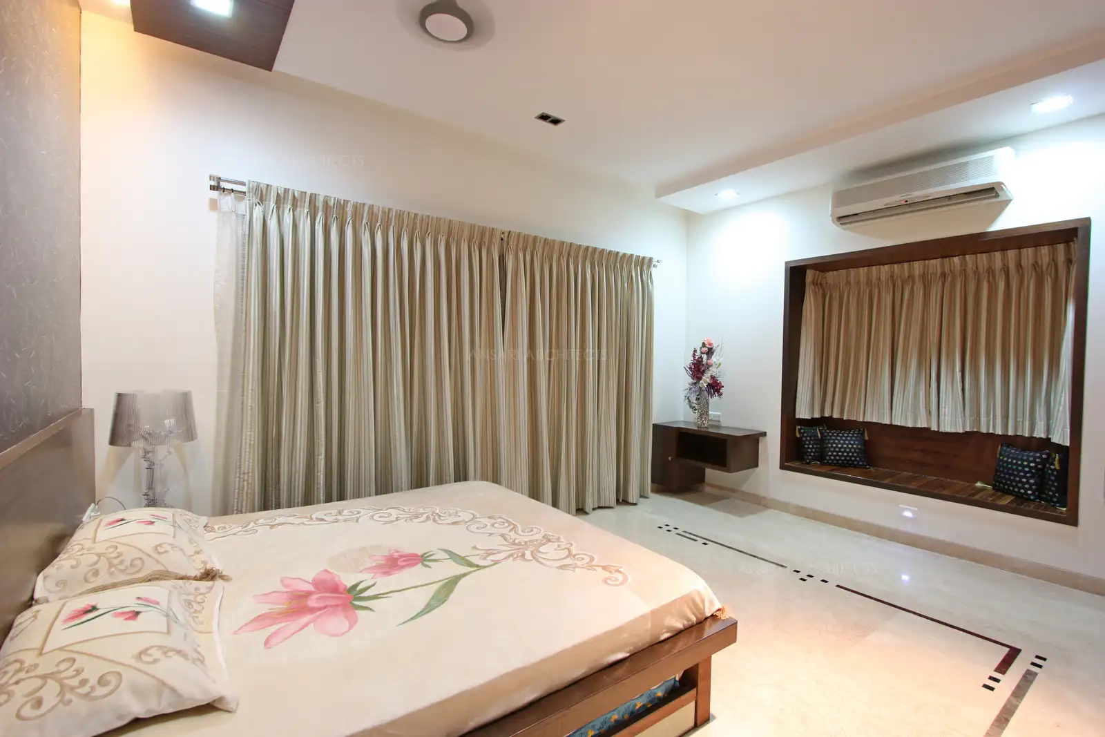 Light colour drapary on large french window and other furnishings make the room look spacious and bright.