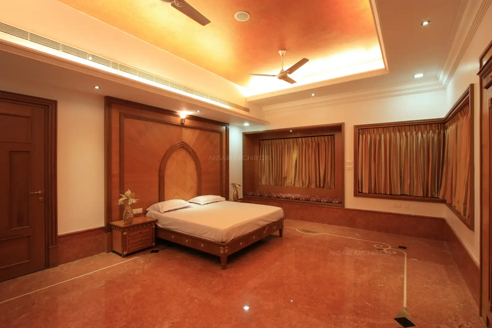 Polished Red Alicante Italian marble with intricate inlay matches with the veneer used in the master bedroom and gives a luxirious look.