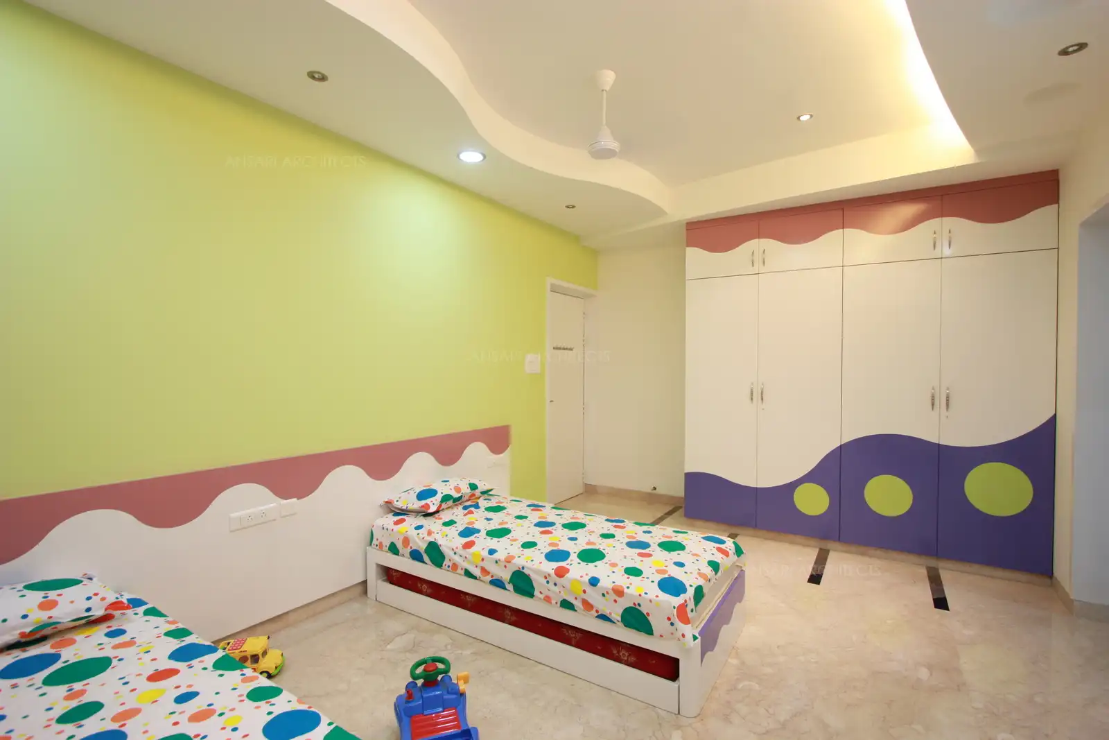Primary colours and curves dominates this kids's bedroom in first floor which is designed for two kids.