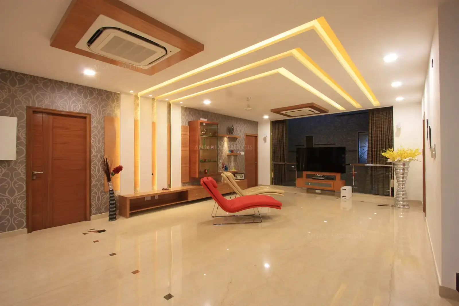 View of simple and sleek false ceiling and courtyard in the family room divided by glass and stainless steel railing.