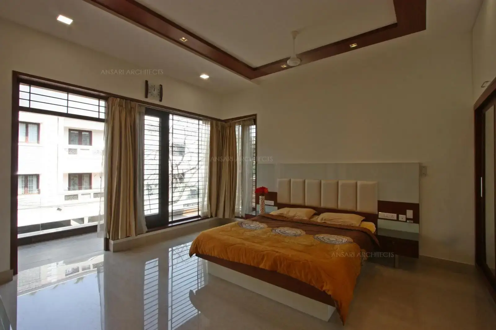 The large openings bring in natural light, corne window adds elegance. The marble flooring provides a distinct character.The entire bedroom is bright and spacious.