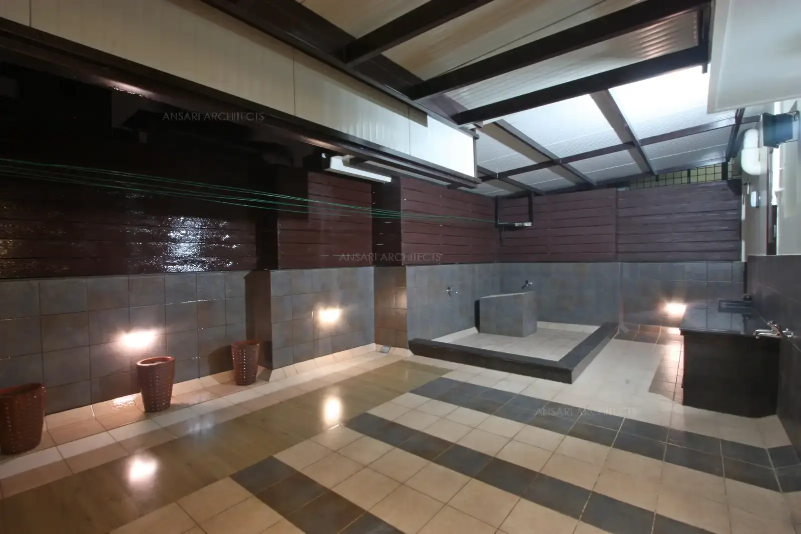 he terrace is detailed with large concrete seater with neutral motifs reflecting functionality integrates with wooden planks on the walls and with connection to the roof, wash area is separated through a ledge wall.