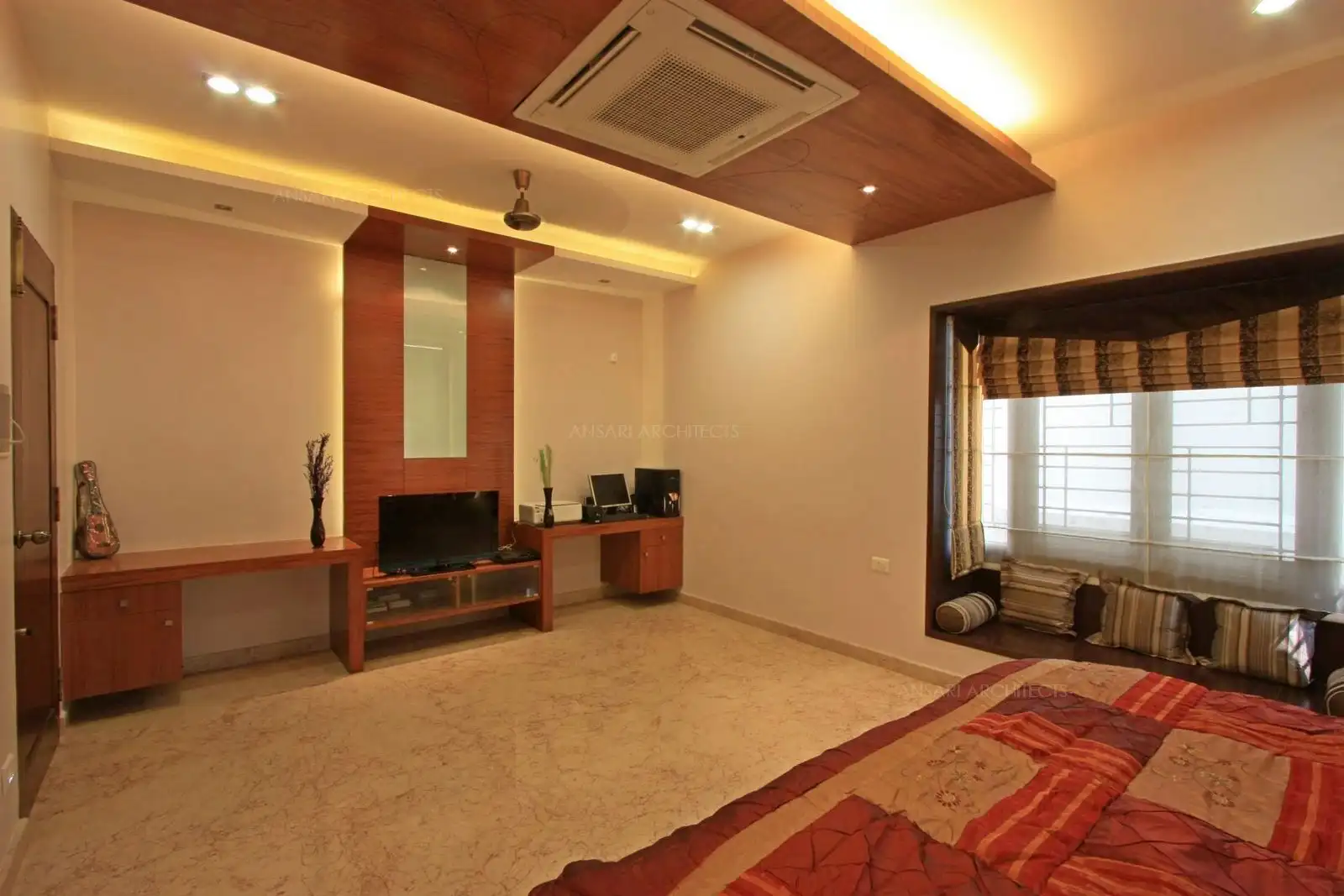 Two study tables have been planed in this bedroom-2 in first floor with a TV unit.
