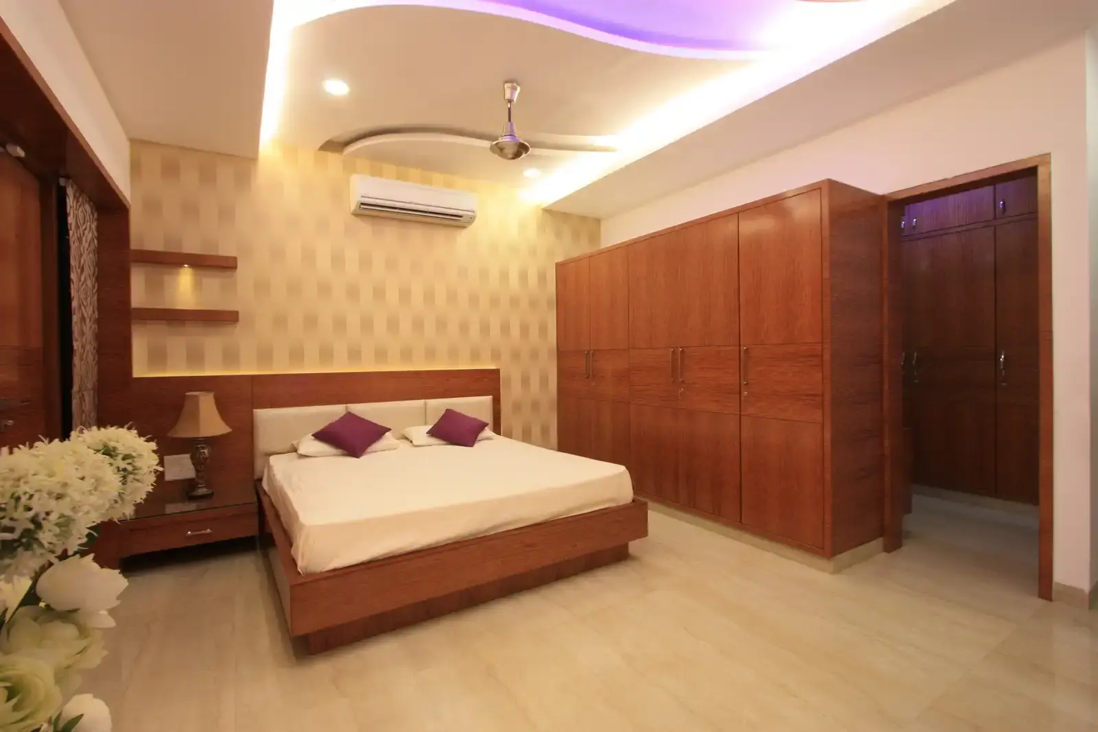 A simple wall paper and furniture done with single shade of veneer make this bedroom-3 sleek and spacious.