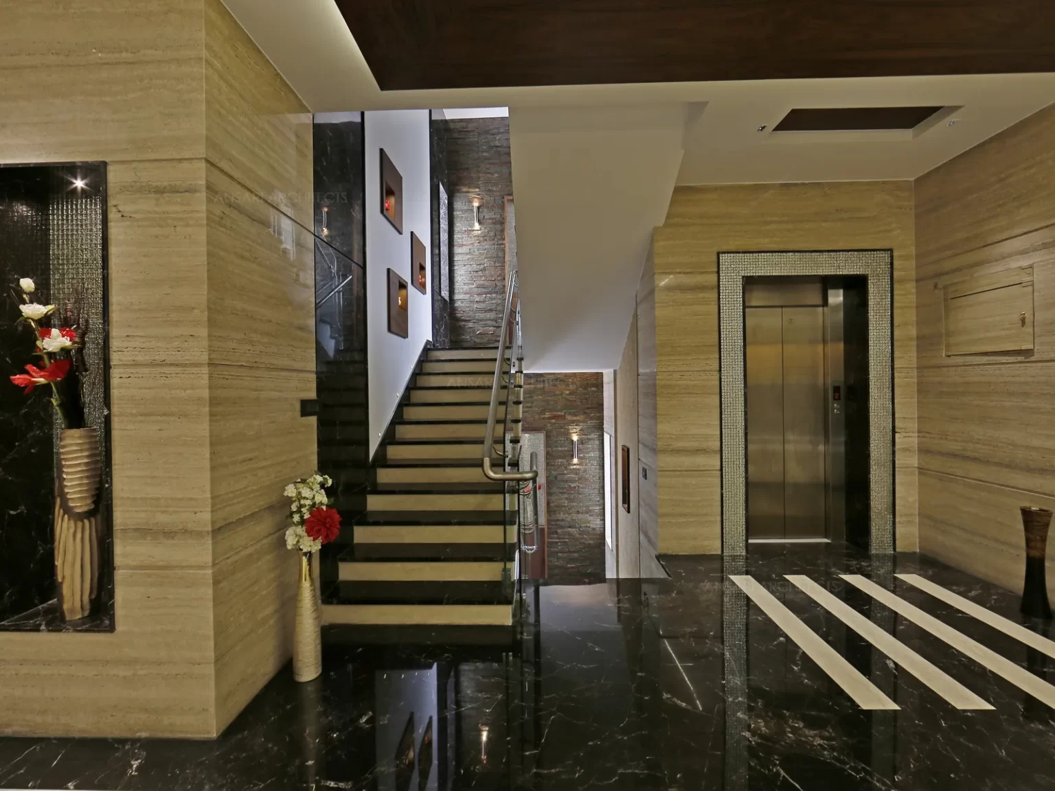 The marble cladding in the walls tie it all together harmoniously, the modern and elegant perfectly balances grandeur and functionality. The staircase with wall niches in veneer and rough textures diffuse the deep tones.