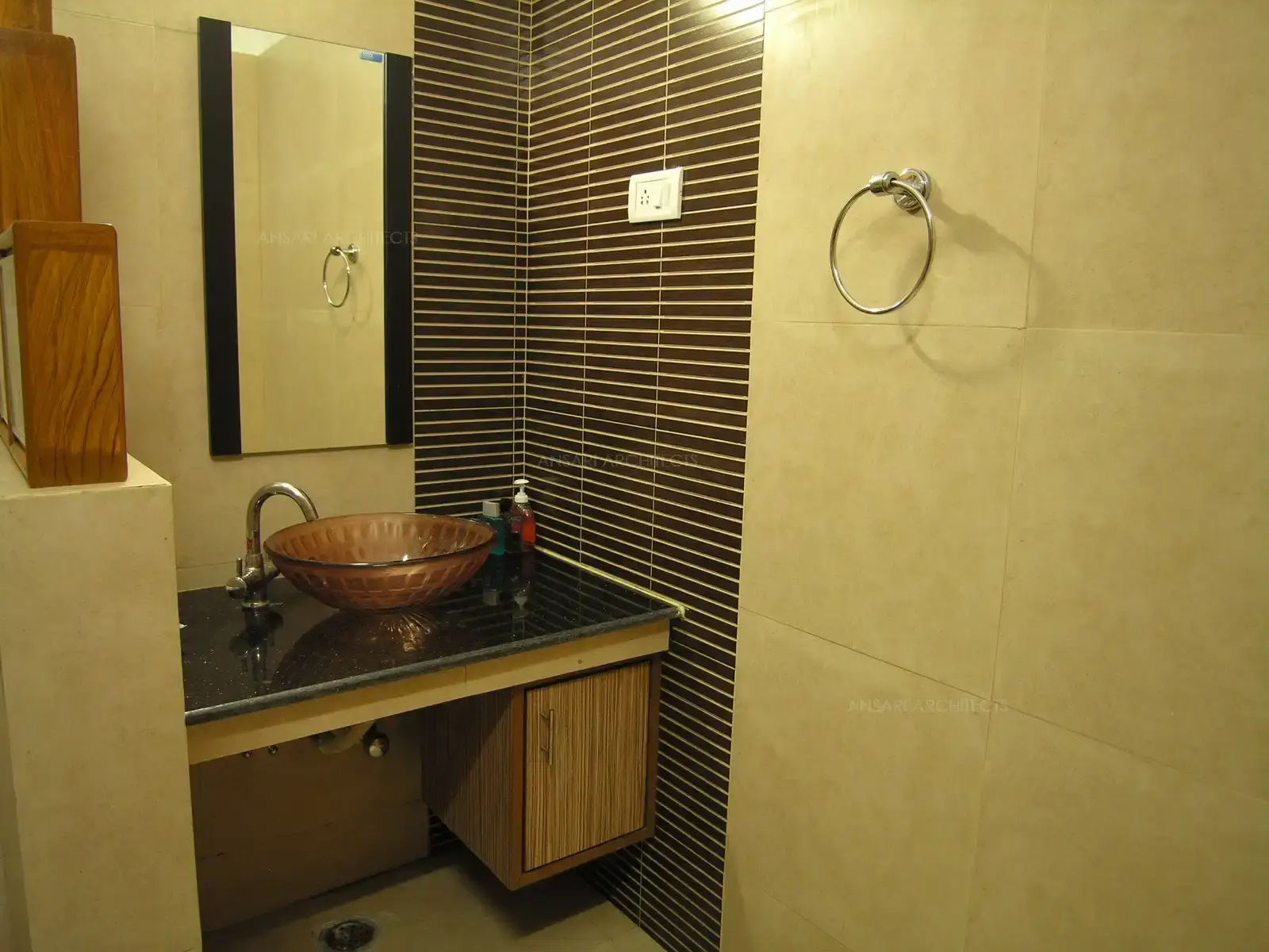 Toilets have been designed in simple contemporary tiles in strip highlighters.