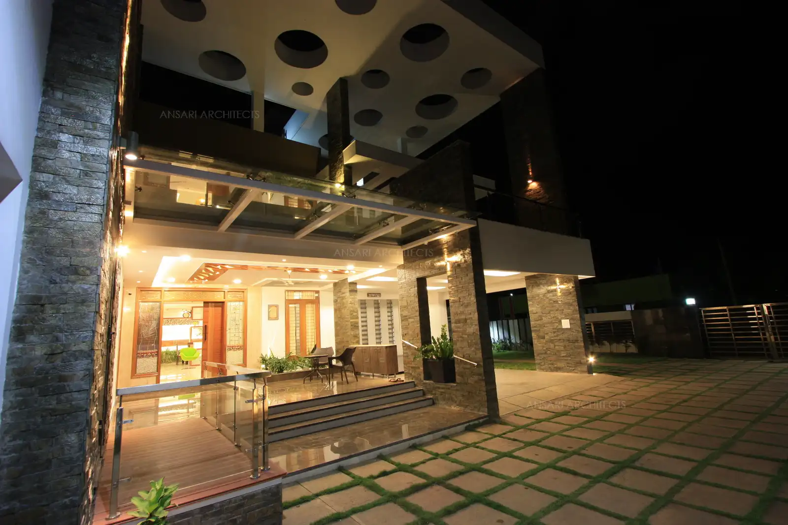 Exterior view showing veranda at an elevated level and glass canopy which goes well with the pergolas.