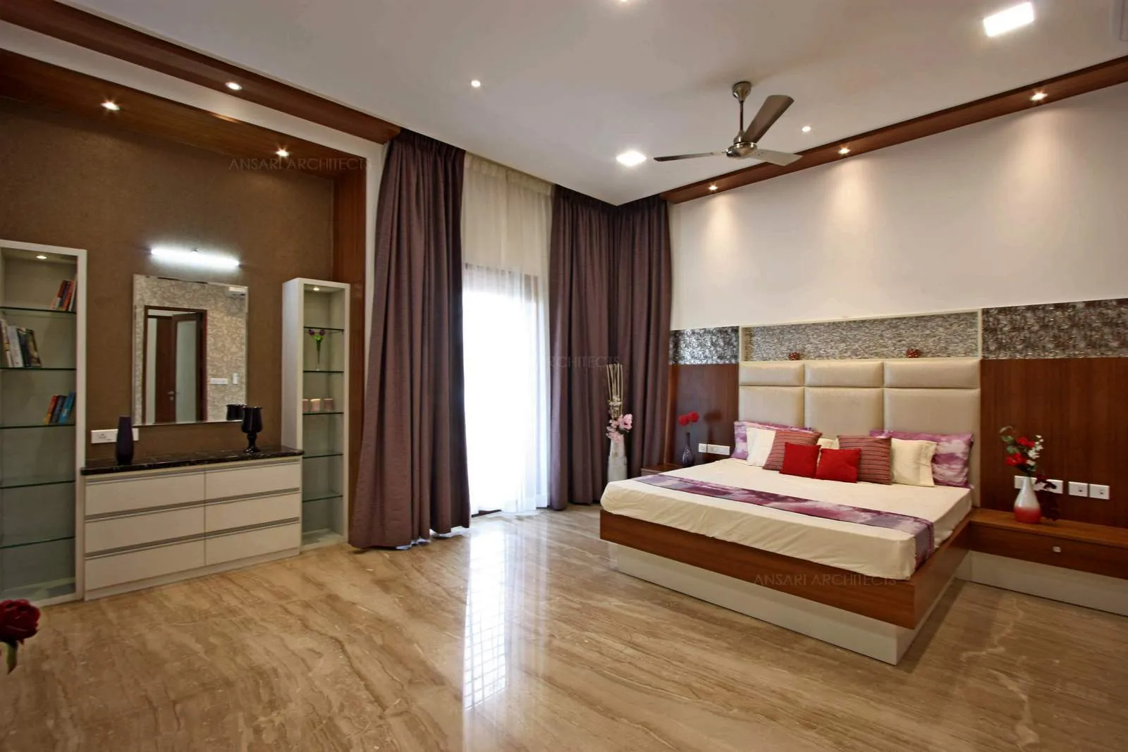 The warm and comforting bedroom is done with soothing shades of brown. Same hues and tones of the brown bring in sense of harmony and fabrics recessed lighting create an aura of comfort.